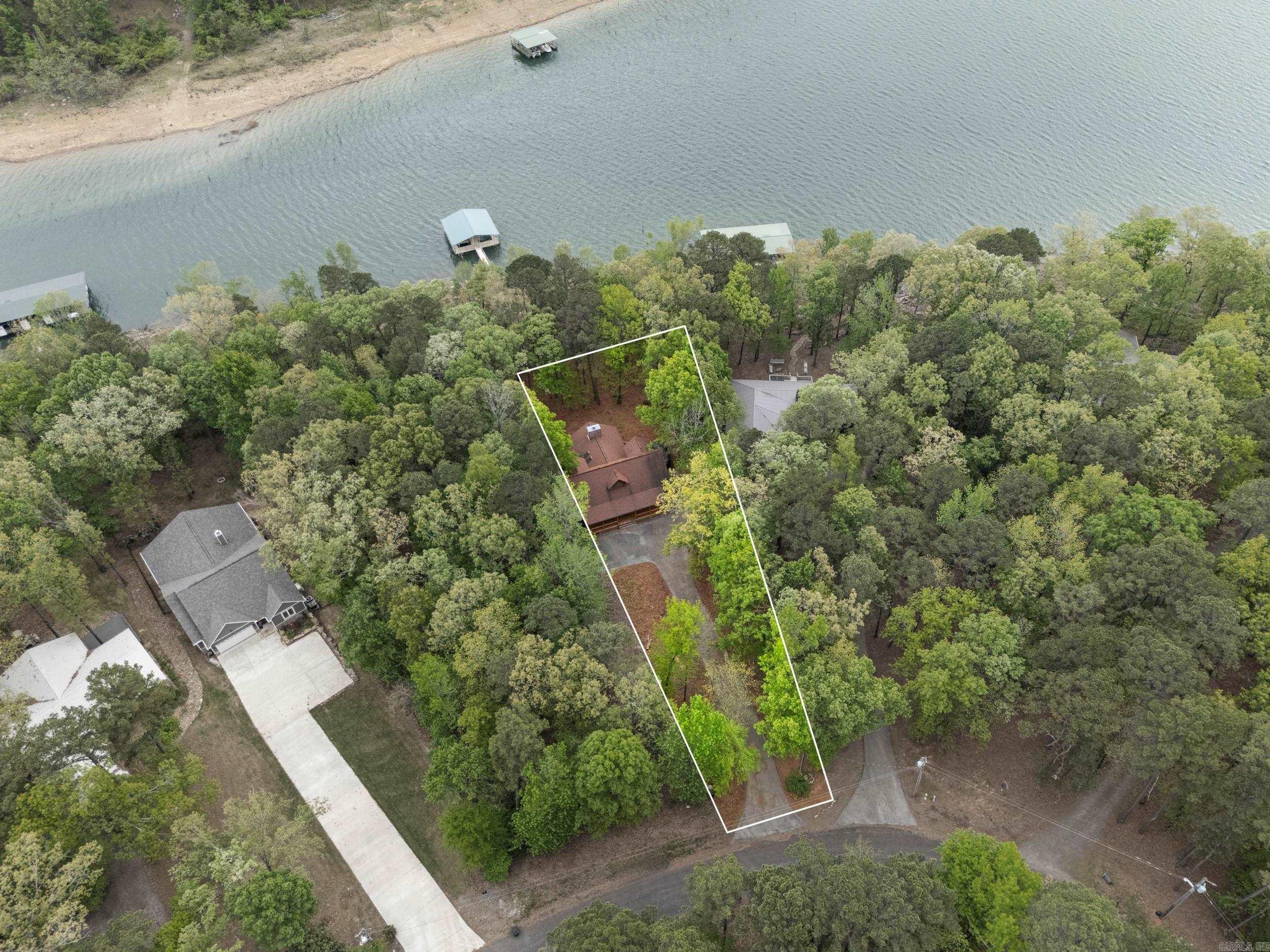 Experience the best of waterfront living in this spacious 3-bedroom, 3-bath lakefront home offering 2348 square feet of finished living space plus 1216 square feet of unfinished walkout basement ready for your vision. Comes with a private 2 boat slip, this property is ideal as a full-time residence, vacation home, or income-producing investment. The main level features an open-concept layout filled with natural light and highlighted by beautiful lake views. The kitchen flows seamlessly into the living and dining areas, creating an inviting space for entertaining family and friends. The primary suite provides a relaxing retreat along with its own bath, while two additional bedrooms each have full baths ensure comfort and privacy. The unfinished basement presents incredible potential, perfect for adding additional bedrooms, a media room, gym, or expanding living space to suit your needs. Step outside to a spacious deck overlooking the lake, ideal for morning coffee, sunset views, and outdoor entertaining. Enjoy direct access to boating, fishing and all the water activities. Make this excellent property yours, come and see for yourself.