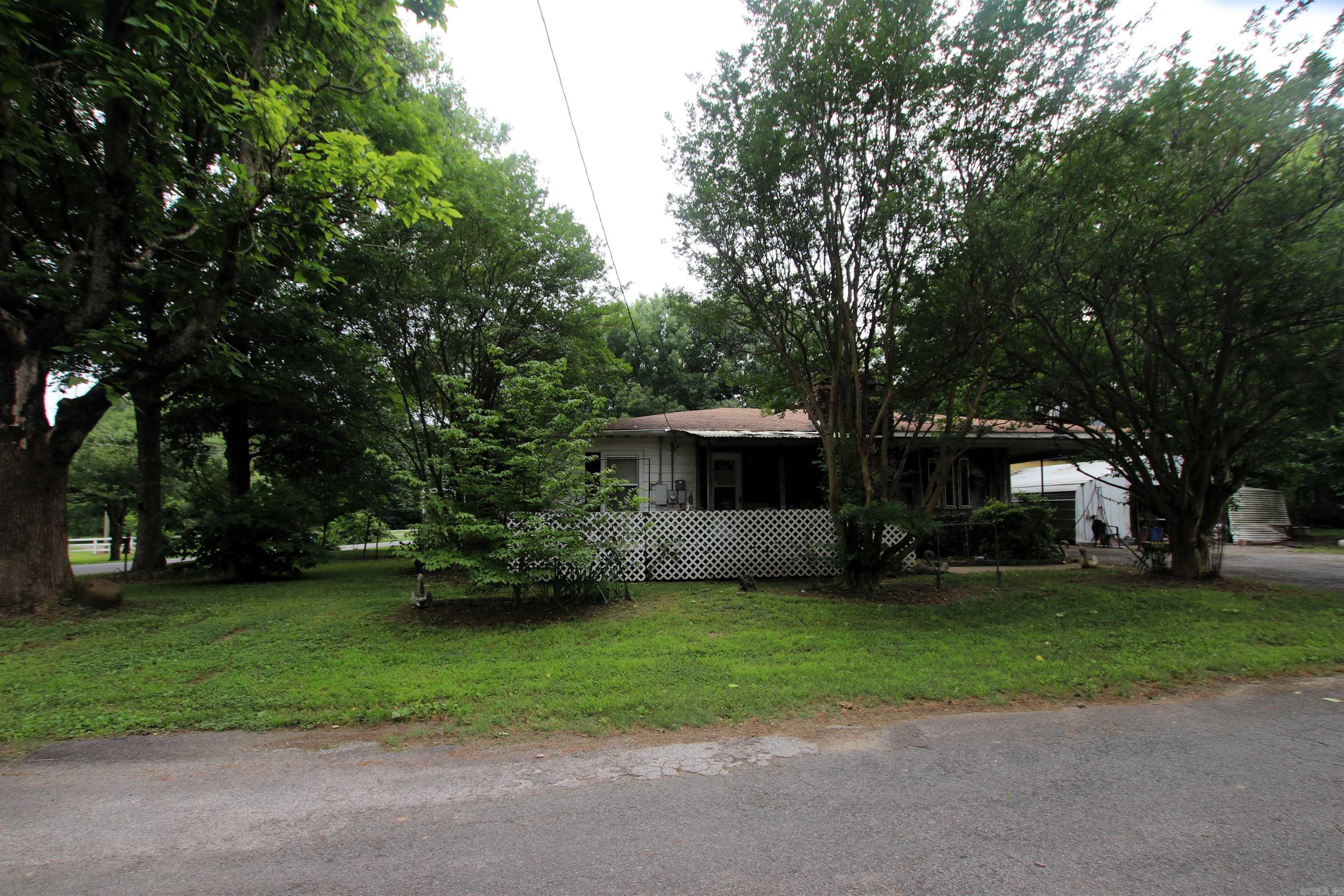 Conveniently located just 0.4 miles from Interstate 40, this well-maintained home offers the perfect blend of space, functionality, and accessibility. Situated on approximately 0.5 acres in the South Conway County School District, the property features 2,012 square feet of comfortable living space with flexible 3 or 4 bedroom options and 2 full bathrooms.  Inside, you’ll find a layout designed for both everyday living and entertaining, while outside offers plenty of room to enjoy a large yard, covered parking, and multiple utility buildings perfect for storage, hobbies, or workshop space.  Enjoy the convenience of being only 15 miles from Conway while still having the feel of country living with room to spread out. Whether you’re looking for a starter home, space for an expanding family, or an investment property this one checks the boxes.
