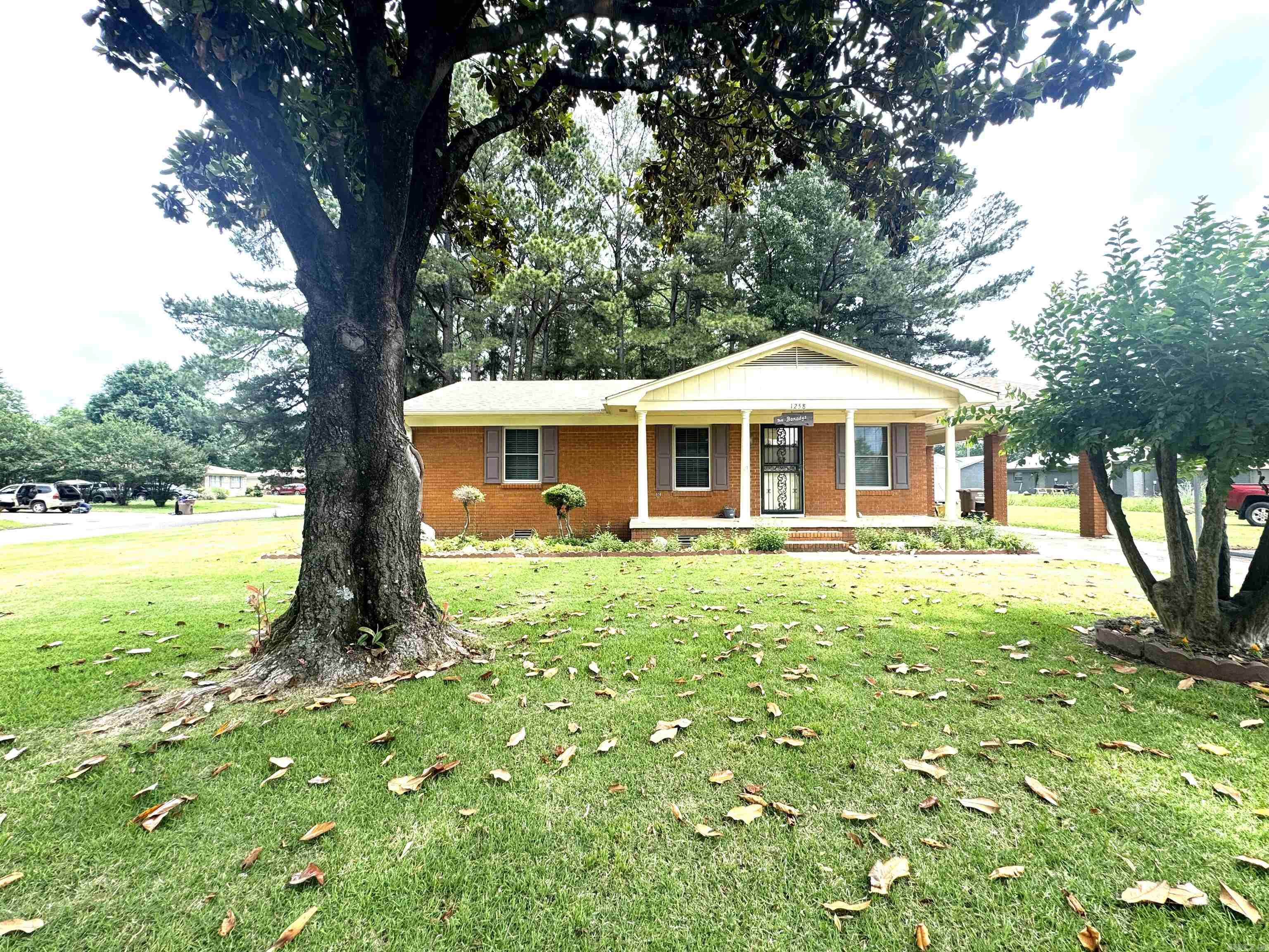 This charming 4 bedroom, 2 bath brick home situated on a desirable corner lot is well maintained and offers a spacious layout with durable LVP throughout most of the home.  The large primary suite is privately located at the back of the house and features a walk-in closet, ensuite bath with shower, and convenient washer and dryer connections.  The home includes 3 linen closets, providing excellent storage space, along with 2 outdoor storage sheds for tools. lawn equipment, or hobbies.  The hall bath features a tile floor and tub/shower combination.  An additional update includes a roof that is 5 years old.  With its functional floor plan, ample storage and attractive brick exterior, this home is ready for its next owner.