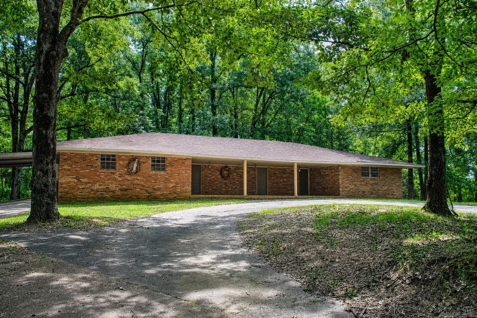 Discover the privacy and possibilities of country living with this spacious 2,494-square-foot brick home situated on 12 secluded acres bordering National Forest land. Inside, you’ll find four bedrooms, two bathrooms, a formal living room, comfortable den, dedicated office, and game room—plenty of space for everyday living, working from home, and entertaining. A large front porch offers a peaceful place to relax and enjoy the wooded surroundings, while the expansive carport provides generous covered parking. A newer HVAC system adds year-round comfort. Surrounded by mature trees and open lawn, this rural retreat offers abundant space, natural beauty, and exceptional seclusion. Whether you’re looking for a private homestead, weekend getaway, or room to enjoy the outdoors, this property is ready for your vision.