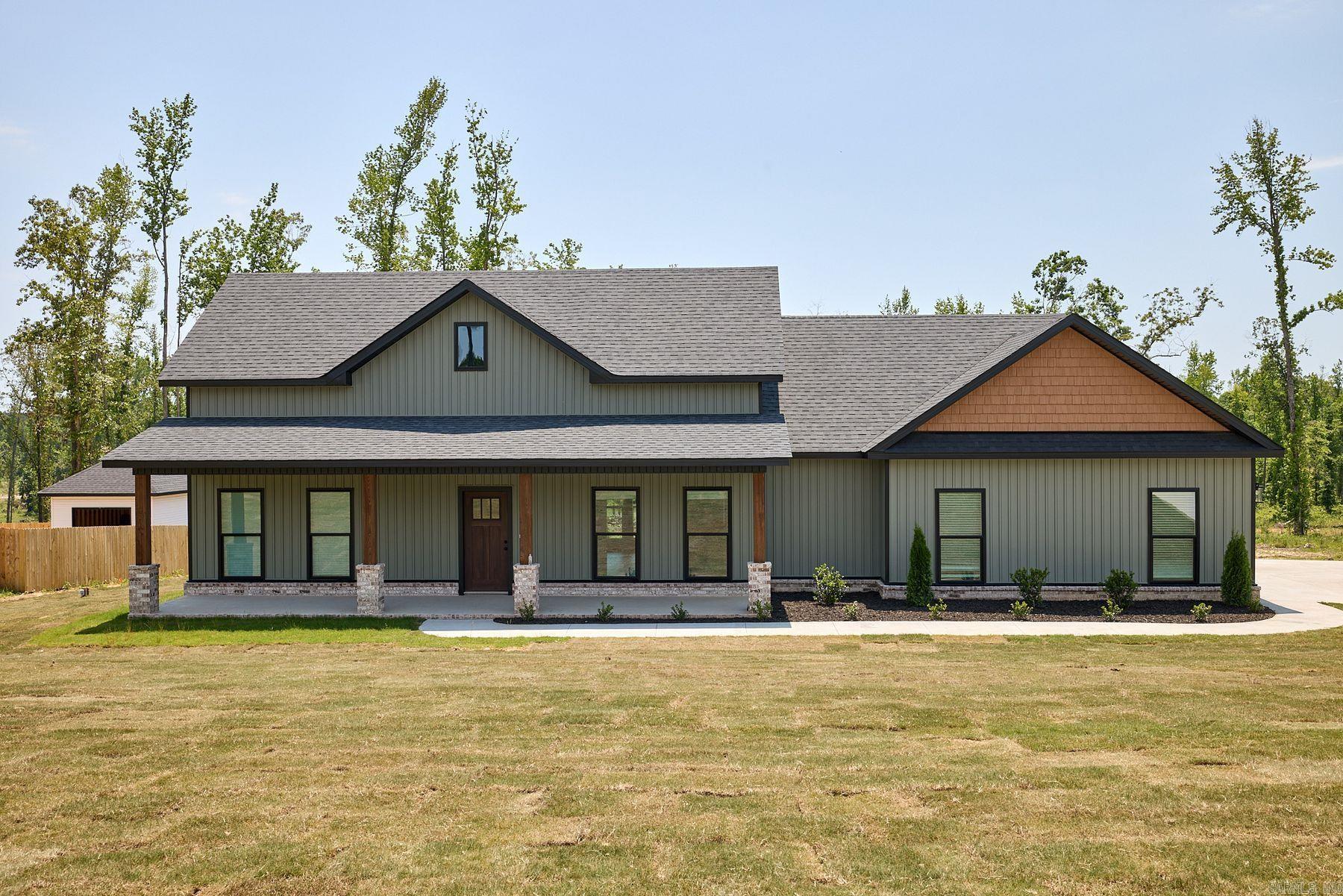 Welcome home to this beautiful 3 bed, 2 bath property situated on 1 acre in Bauxite! This inviting home features custom beamed wood ceilings, quartz countertops, a spacious dinning room, large foyer, walk-in pantry, 2 car side entry garage, and a cozy wood burning fireplace perfect for relaxing evenings. The primary suite offers a standing tub and walk-in shower. Enjoy peaceful mornings and evenings on the oversized front and back porches. A 12x20 shop provides extra storage or workspace. With thoughtful details, spacious living areas, and charming country appeal, this home is a must see