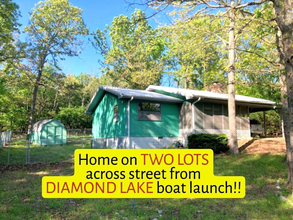 ENJOY BEAUTIFUL LAKE VIEWS OF DIAMOND LAKE! This charming 2-bedroom, 1.5 bath home sits on TWO LOTS directly across from the Diamond Lake boat launch in Horseshoe Bend, AR — the perfect spot for lake lovers, first time buyers, or anyone dreaming of an affordable vacation getaway. Step inside and you’ll find updated carpeting, updated bathrooms, and a native stone wood burning fireplace that makes the living room feel warm and inviting all winter long. A screened in front porch lets you relax and enjoy the cool lake breezes all summer. Major updates give you peace of mind, including: New metal roof in 2024- also New chain link fenced backyard — ideal for kids or pets.  Updated septic system (June 2024) with new pump tank & field lines.  All appliances included — even the washer & dryer.  This home has QUICK OCCUPANCY and is priced to sell at NEW PRICE OF $124,900. Opportunities like this don’t last long. #2427 Measurements from Data Scout