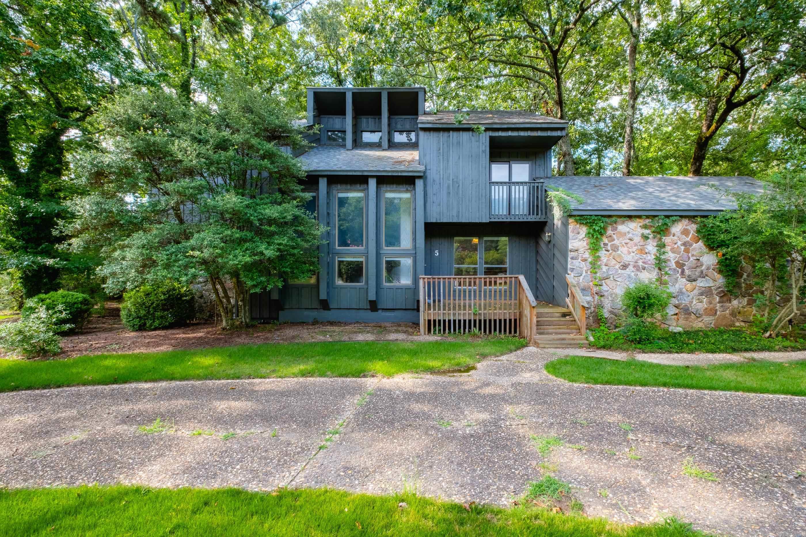 You will love the architectural charm of this one-of-a-kind mid century modern home! This spacious 4-bedroom, 4-bath home is positioned on an oversized corner lot in the heart of Maumelle. As you enter the home, you'll love the terra cotta inspired ceramic tile flooring the entry way.  The double-sided stone fireplace, vaulted ceiling and dramatic wood walls are just a few of the rare interior features.  The main level features two living spaces, an eat in kitchen, two full bathrooms and a guest room.  Upstairs you'll find the primary bedroom with a stunning en-suite bath, two guest rooms joined by a jack-and-jill bath.  The expansive backyard and large covered porch provide a true retreat, backing up to a canopy of mature trees and providing direct access to a convenient walking trail—perfect for evening walks or simply enjoying the outdoors.  Don't miss this rare opportunity in a fantastic location.