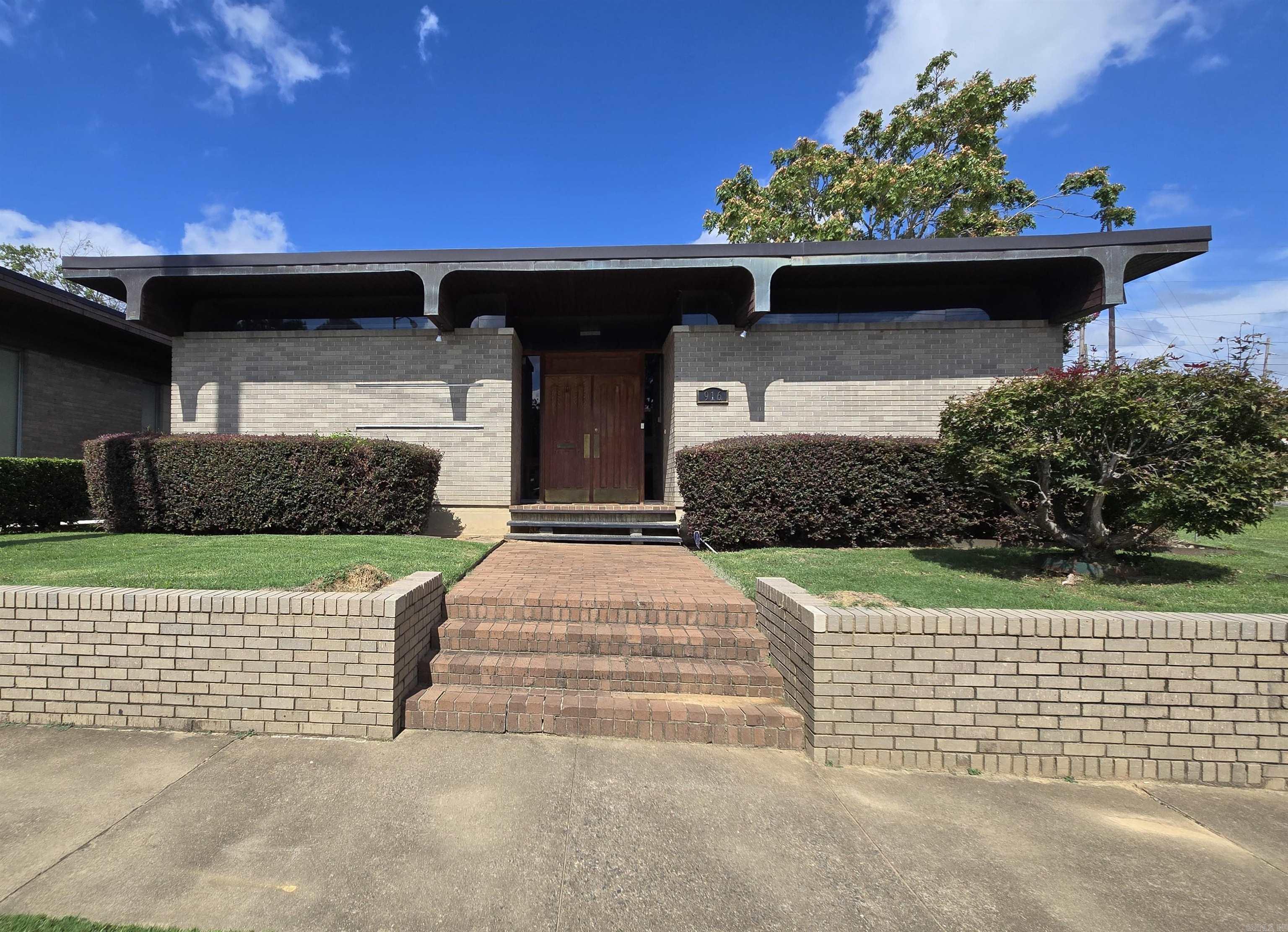 This mid-century modern building offers a distinctive space ideal for a law office, medical practice, or financial firm. Inside, you'll find stunning library paneling and unique ceilings that add character and warmth. The property includes four private parking spaces at the rear, and the adjoining lot is now included in the sale, providing additional parking, expansion opportunities, or a potential future building site. With high visibility from Cantrell Road and close proximity to downtown, it offers excellent accessibility for clients and staff. Owner financing may be available, providing flexible purchase options for qualified buyers.