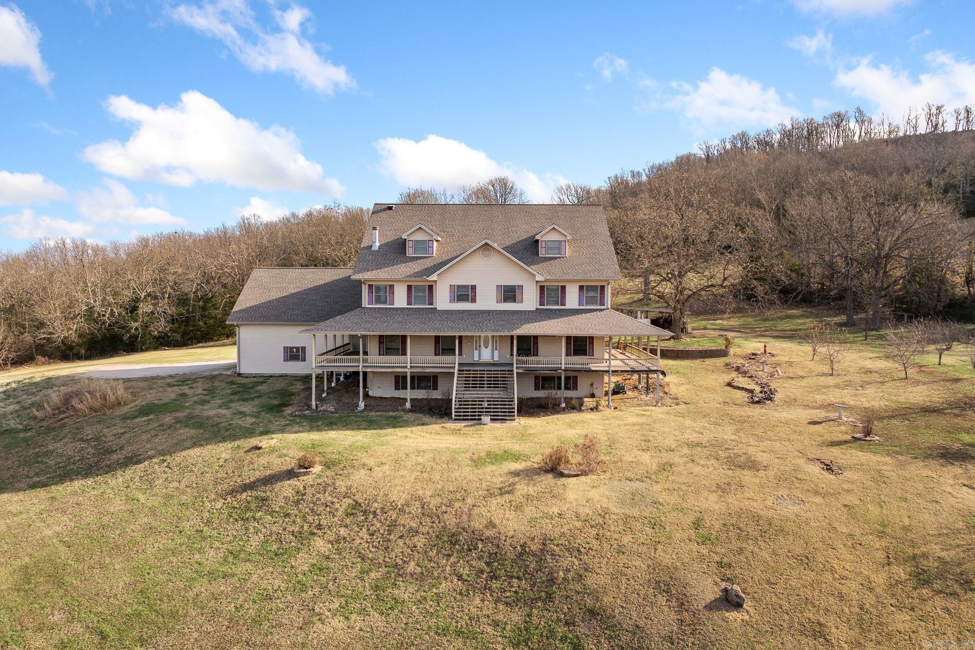 One-owner, custom-built 9,600 sq ft home offering exceptional space, privacy, and panoramic views in the Arkansas Ozarks. This impressive property features 6 bedrooms plus a bonus room, 4 full baths, and 2 half baths. Designed for comfort, durability, and large-scale entertaining, it’s ideal for a Bed & Breakfast, Airbnb, or corporate retreat. The home easily accommodates guests with its generous layout and multiple living areas. Key features include a whole-house generator, in-house sprinkler system, outdoor Hardy wood furnace, propane cooktop, multiple HVAC systems, and a brand-new roof (2023). It also offers a spacious three-car garage and solid construction throughout. Available on ~10 acres or ~40 acres (with pond and barn). Enjoy absolute privacy, usable land, and breathtaking long-range views from every level. Located just outside Big Flat and Harriet, with Marshall and Mountain View both about 30 minutes away.