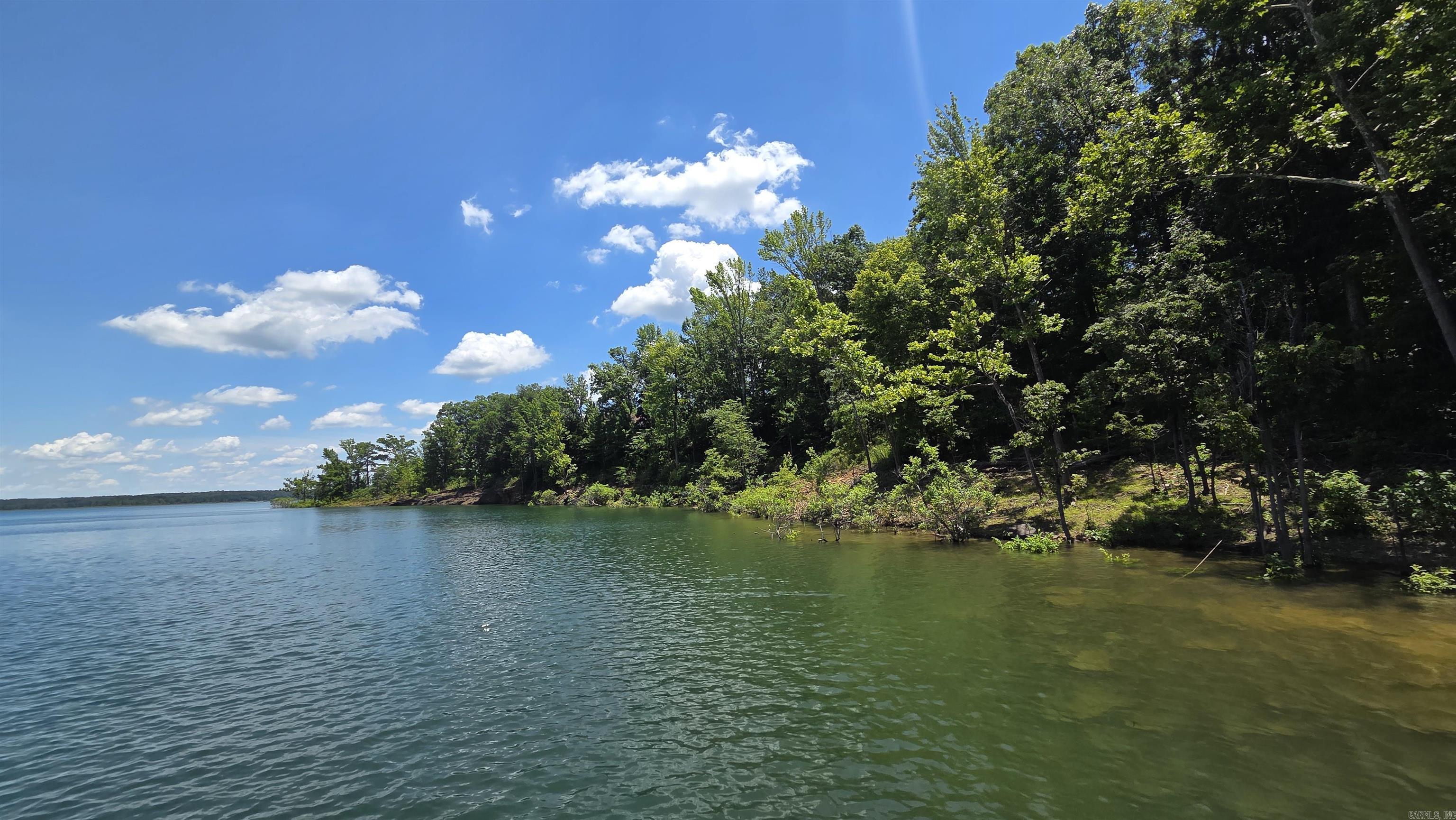 **Ready to Build Your Dream Home on this Beautiful Lakefront Lot?**  This prime lakefront & lake view lot is ready for your new home! Builders are available to meet with you and help bring your vision to life.  The white line marks is neat the water line (so close). Located in a peaceful, quiet cove, this lot offers incredible amenities including **free access to a swimming pool** for lot owners, plus two additional community pools and approximately **100 miles of UTV/SXS trails**.  Utilities are already at the street at this lot: sewer, power, water meter, and fiber internet — all on a paved road in a private cul-de-sac.    This lot truly has it all! Call today to schedule your private tour of the property, the pools, and all the amazing amenities this community has to offer.