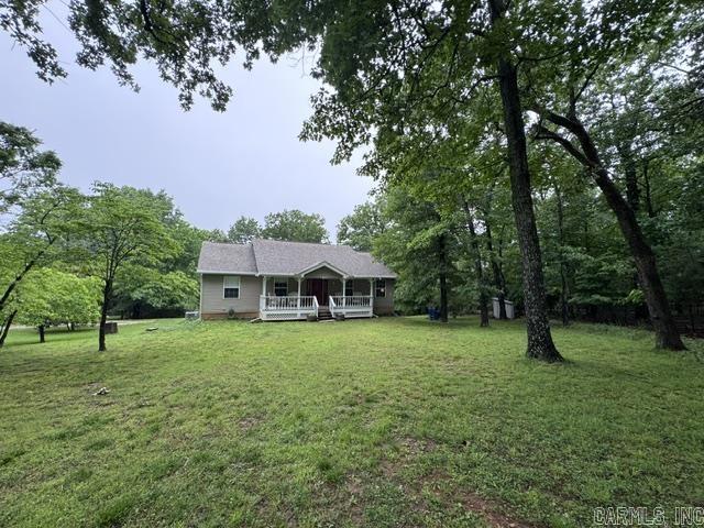 Minutes from Norfork Lake Access! This one owner home is a custom-built home, well maintained and shows pride in ownership! Located at the end of the road and offers plenty of woods and privacy. Home features a well thought out kitchen, three bedrooms including the primary bedroom/bath on the main level, living room with wood burning Vermont casting stove and custom built in shelving in the Living room and spare bedrooms. The Basement features its own living area, bathroom, bedroom and KITCHEN! Outside you will find a fenced back yard, covered front porch, an open back deck, detached 2 car garage with workshop and attached lean to. There is also a detached custom-built storage building. Newer heat pump and roof. This is a must see property!
