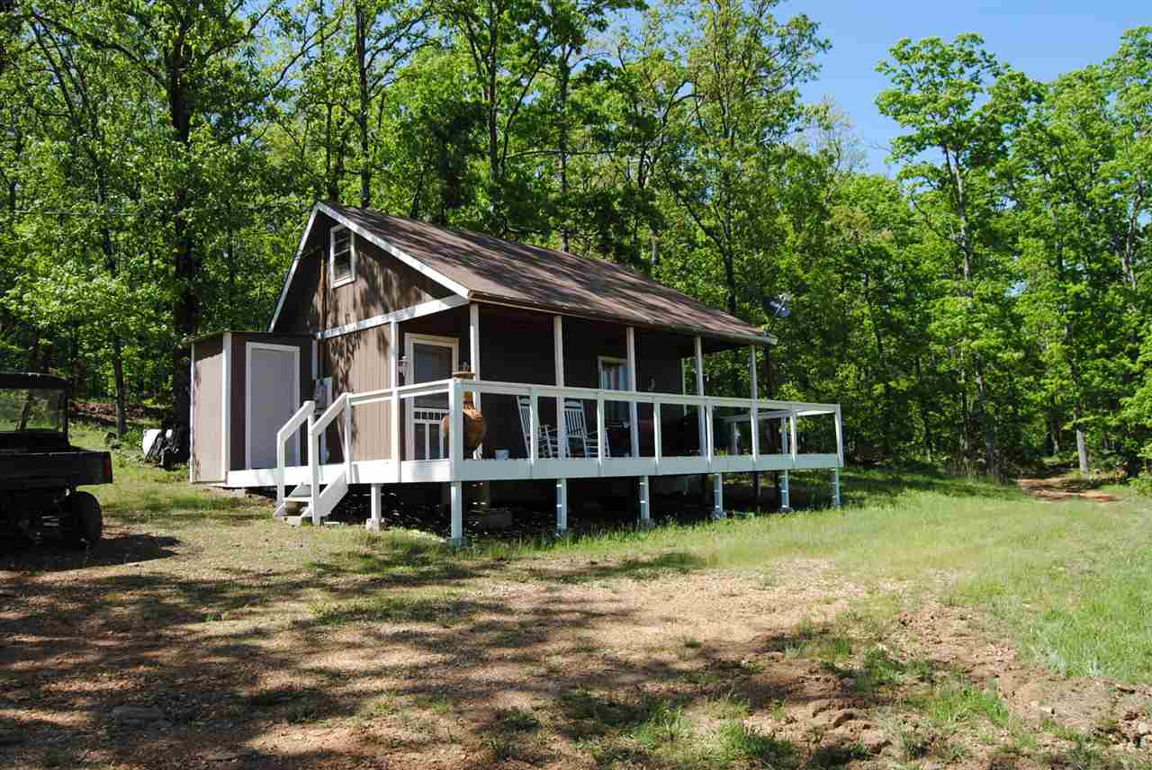 A NICE VIEW WITH YEAR ROUND RED RIVER RUNNING ON PROPERTY , A MOVE IN CABIN, COMPLETE FURNISHED, ALL NEED IS CLOTHES AND FOOD, A NICE DECK AND COVERED PORCH 28 X 32 . HAS HOOK UP FOR WASHER AND DRYER, TONGUE AND GROOVE ON WALLS AND CEILING, 150 GALLON PROPANE TANK WITH GAS, 2 NICE ROCKING CHAIRS , A GRILL, A FIRE PIT ON PORCH, TIN CEILING INSIDE, GUTTERS, DISH HOOK UP IN PLACE, RURAL WATER ( SOUTH MOUTAIN WATER) NEW HEAT AND COOL SYSTEM , GAS FIREPLACE, DINING TABLE, NEW PLEX INSTALLED WATER PIPE, PRICE SEL