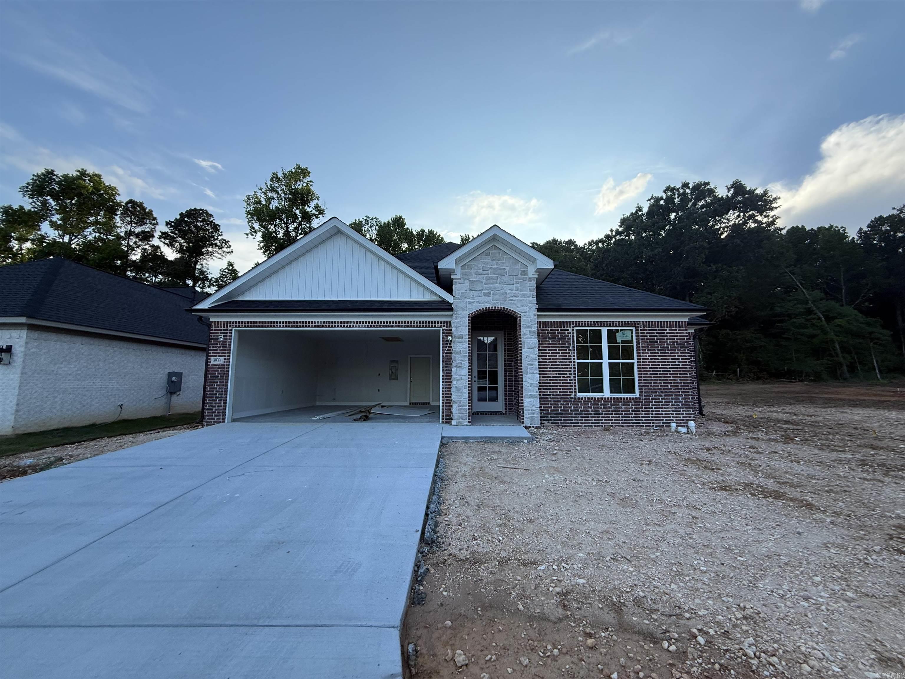Welcome to your dream home in Benton’s premier subdivision, Spencer Crossing! This stunning brand new construction boasts a spacious split floor plan designed for modern living. Step into the heart of the home where custom-built, soft-close floor-to-ceiling cabinets adorn the kitchen, complemented by a freestanding stove & a convenient pantry for all your culinary needs. Cozy up by the brick, gas fireplace in the open living area, perfect for entertaining or relaxing evenings at home. Retreat to the private primary suite featuring a luxurious primary bath complete with double vanities and a large walk-in tile shower, offering a spa-like oasis right at home. The split floor plan ensures privacy with spacious spare bedrooms, providing ample space for family or guests. Step outside onto the covered porch & immerse yourself in the tranquility of the backyard, where you’ll love spending time in the expansive outdoor living space. Whether it’s morning coffee or evening gatherings, this home offers the perfect setting for enjoying the outdoors. Don’t miss out on the opportunity to make this beautiful home yours!