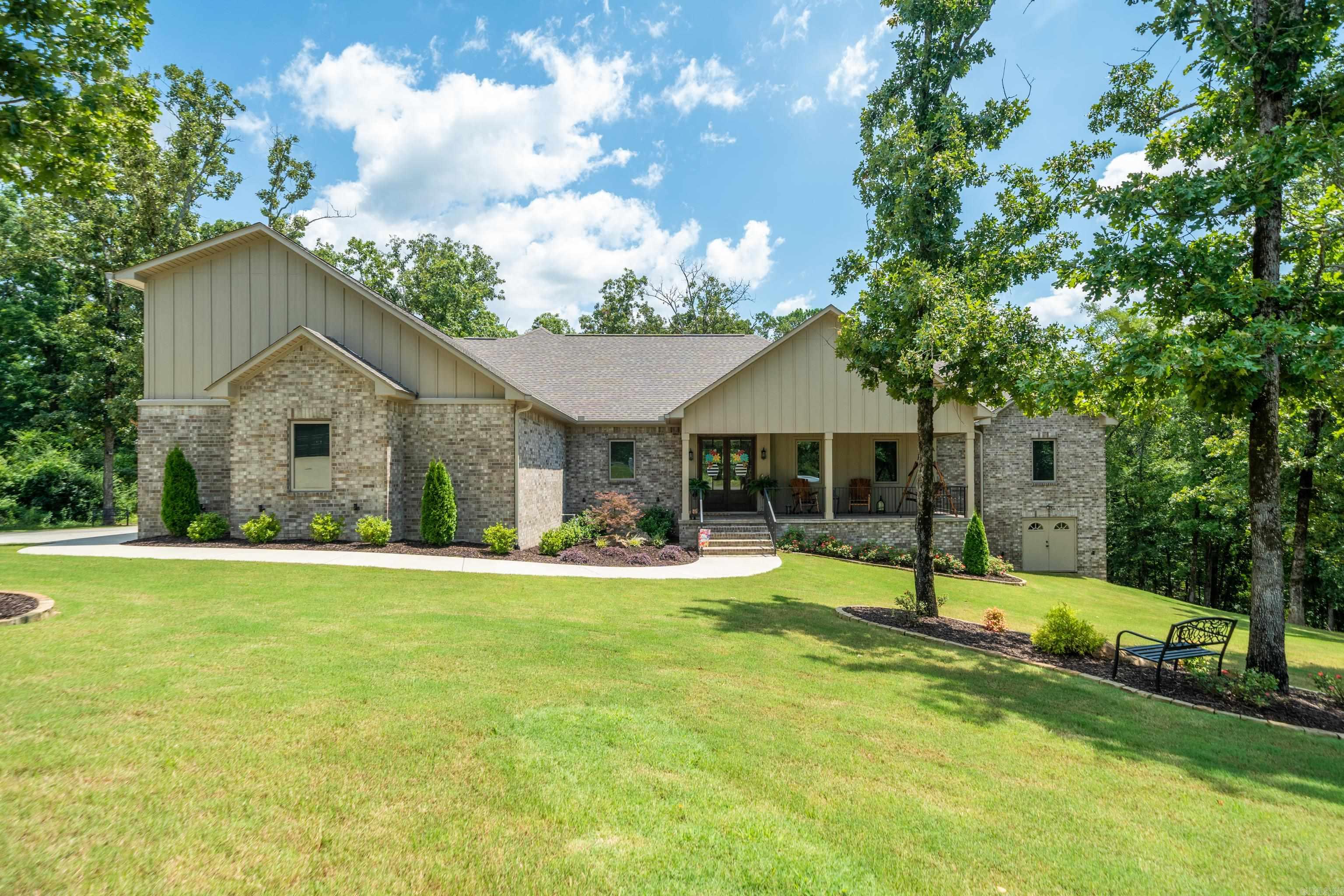 Experience luxury living in the highly desirable Rose Creek subdivision with this recently built custom home, ideally located just minutes from Lakeside Schools and Hot Springs Country Club. This exceptional 4-bedroom, 3.5-bath residence sits on two spacious lots, offering rare privacy and beautiful surroundings. Inside, you'll find an open-concept floor plan designed for effortless living and entertaining, highlighted by a stunning tongue-and-groove ceiling, abundant natural light, and high-end finishes throughout. The gourmet kitchen features premium cabinetry, quality countertops, and a large island overlooking the spacious living and dining areas. The private primary suite offers a luxurious retreat, while the additional bedrooms provide ample space for family and guests. Step outside to an expansive covered deck and generous outdoor entertaining areas perfect for relaxing or hosting gatherings. An oversized 3-car garage completes this remarkable property. Combining custom craftsmanship, premium finishes, privacy, and an unbeatable location, this is a rare opportunity to own one of Rose Creek's finest homes.