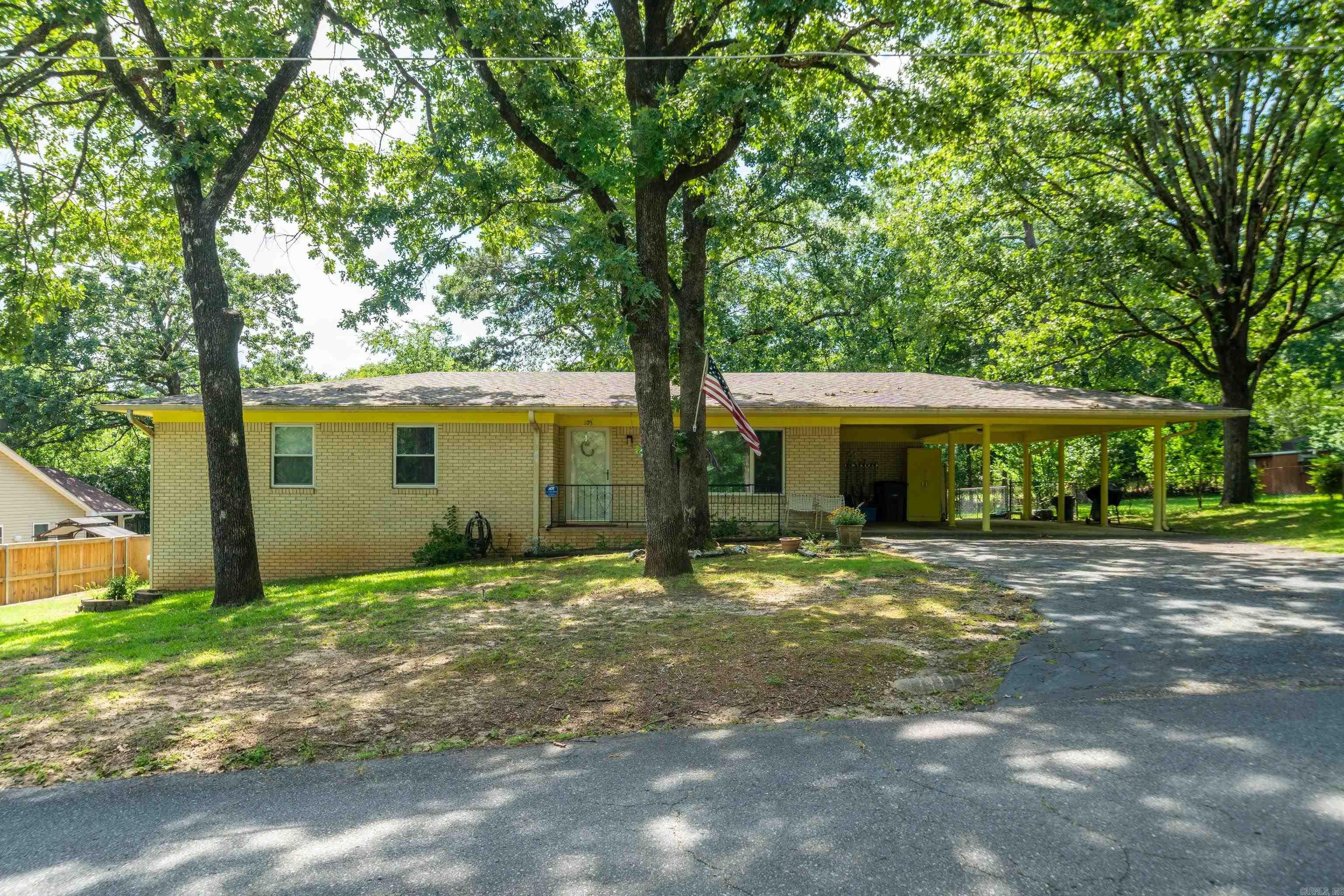 Charming 3 bed/1.5 bath home located in the heart of Hot Springs! This well-maintained home features original, gleaming hardwood floors throughout, adding warmth and character to every room. Spacious gourmet kitchen with updated appliances and tons of cabinet space. The primary bedroom includes a private half bath for added convenience. Enjoy relaxing in the spacious Arkansas room while watching the family of deer that frequently visit the backyard. Outside, you will find a large fenced in back yard, with all new fencing on the left side with RV parking and hookup, plus a storage shed/workshop offering plenty of space for hobbies, projects, or extra storage. The 2-car carport provides covered parking and easy access to the home. Recent updates include a new roof 2024, new gas hot water heater, dishwasher and microwave. Refrigerators and freezer will convey with the property, making this home move-in ready. Conveniently located just minutes from area lakes, shopping, restaurants, and all that Hot Springs has to offer. Don’t miss this opportunity to own a home with space, updates and a fantastic location!