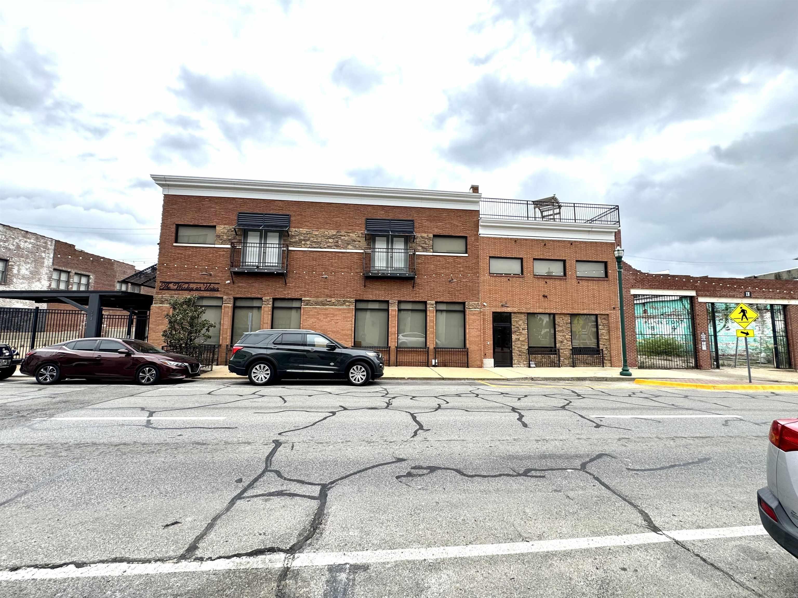 Exceptional multi-family investment opportunity located in the Downtown Jonesboro Entertainment District. This fully occupied property features 11 loft-style residential units and 8 gated parking spaces, generating over $200,000 in gross annual income with potential for increased revenue. The property offers a unique loft living experience within the historic Massinelli's Dry Cleaning Building, combining character with modern amenities. Features include secure gated access, fire sprinkler system, tankless water heaters, and a rooftop patio for tenant only use. Situated in a strong rental market (approximately 52% renter-occupied), this asset provides immediate cash flow and long-term investment stability. One of the few downtown properties offering both loft-style units and dedicated gated parking. Nine 2 bed, 2 bath and Two 1 bed, 1 bath. Perfect for a 1031 Exchange. Financials and additional property details available upon request.