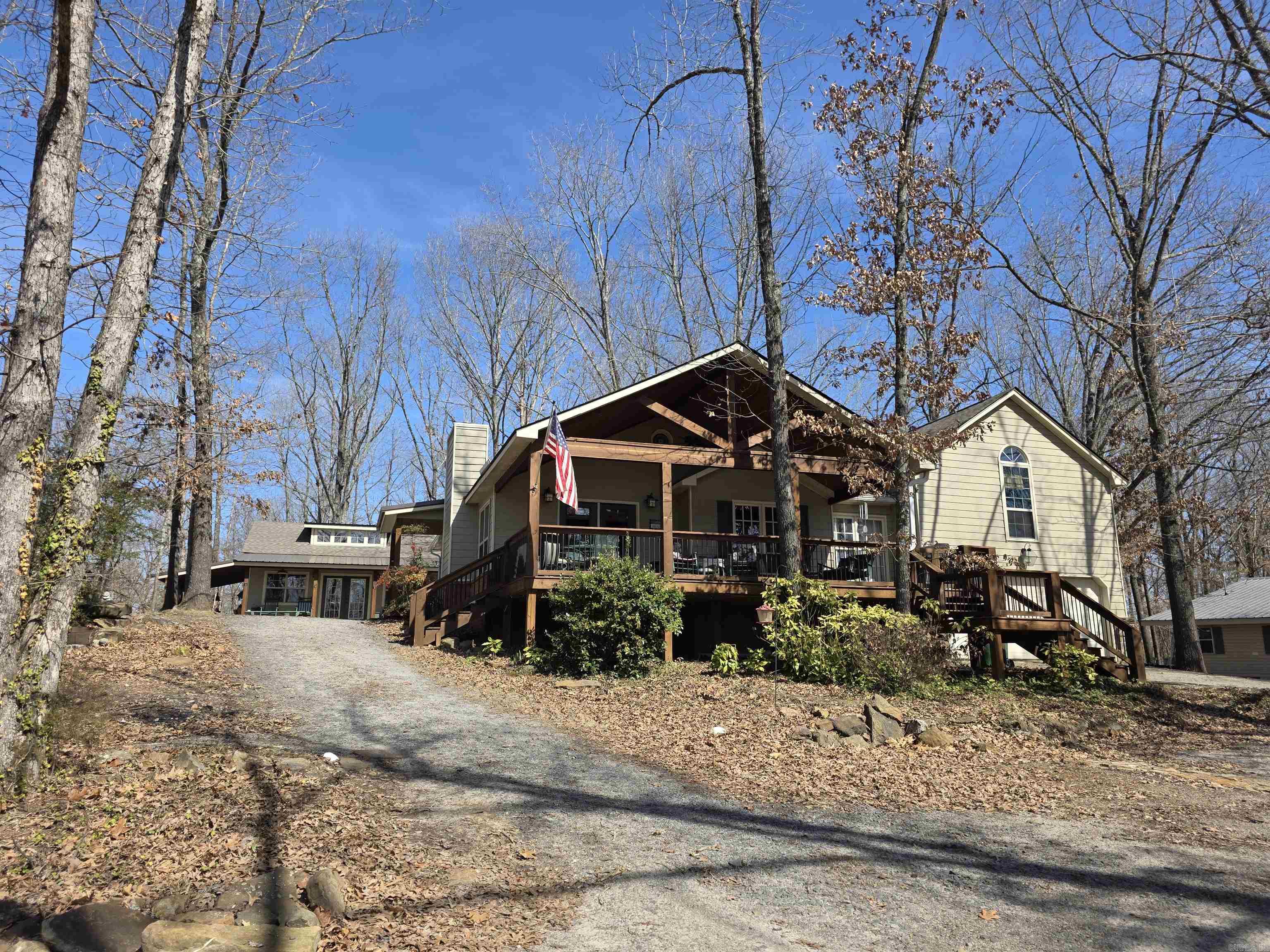 This charming lake area home has been owned by the sellers since 2003 and is in the very pretty neighborhood of Skypoint Estates. Beautiful lake view and local area boat launch within walking distance, right across the street. Custom built shop that is heated and cooled. Could stay as a workshop or make for extra sleeping quarters/bunkhouse. (would need to be plumbed for water if you wanted) Skypoint Estates does have a private airstrip and is just right around the corner from this house. Primary bedroom is above the garage and is completely separate from main floor. Very close to town and within 5-6 miles of all surrounding marinas and local shopping.  Agent see remarks.