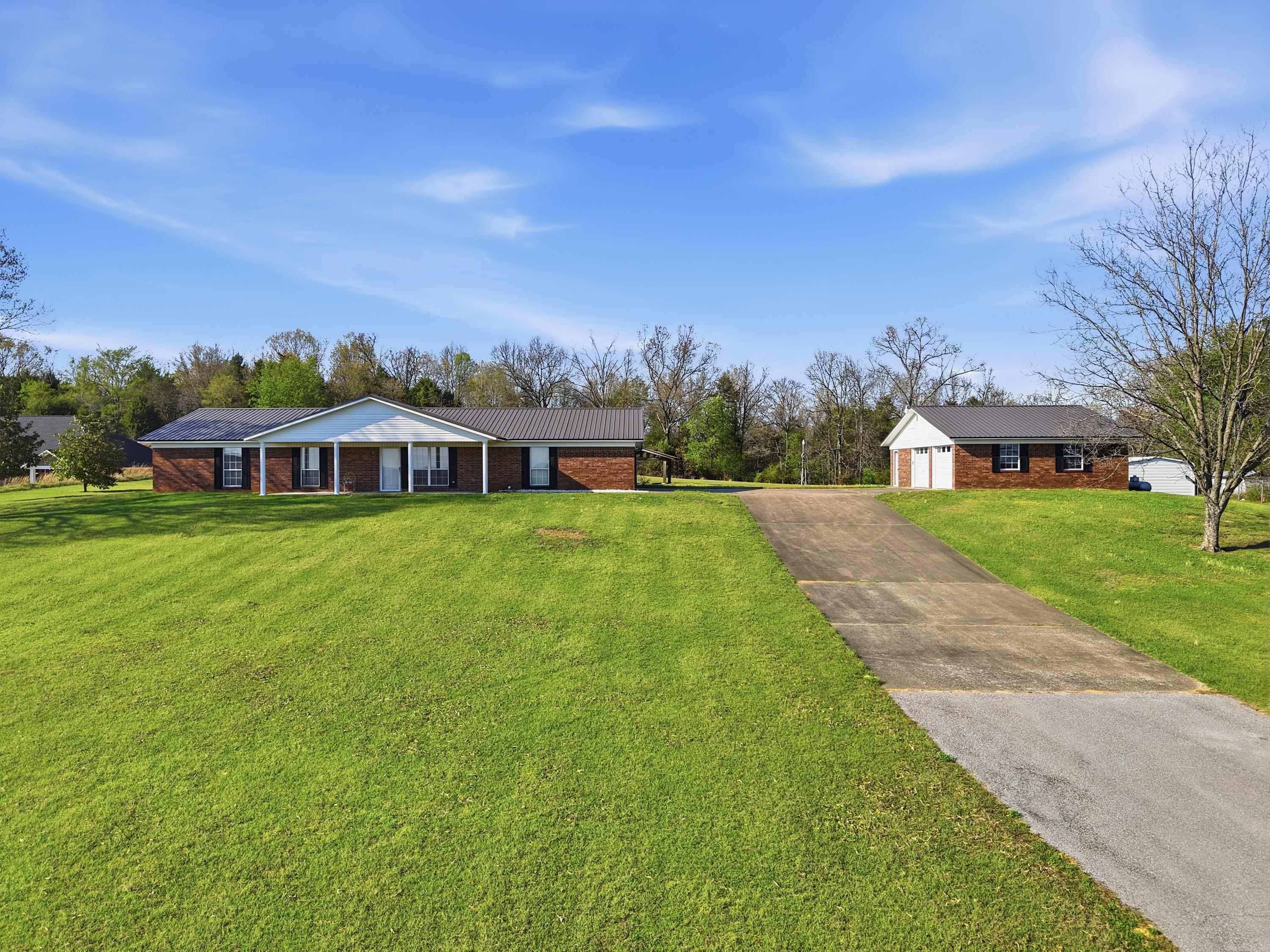 SUBDIVISION  THIS IS THE PERFECT PLACE FOR A SMALL SUBDIVISION WITH THE DRIVE WAY UP THE MIDDLE OF THIS  7.5 acres. LARGE 3 bed 2 bath home/office has shop with 2 doors 25x32 and 2 car garage. 18x20 outbuilding, storm shelter, hobby storage building. animal fenced area.  Double oven,pantry and heater for extra heat.