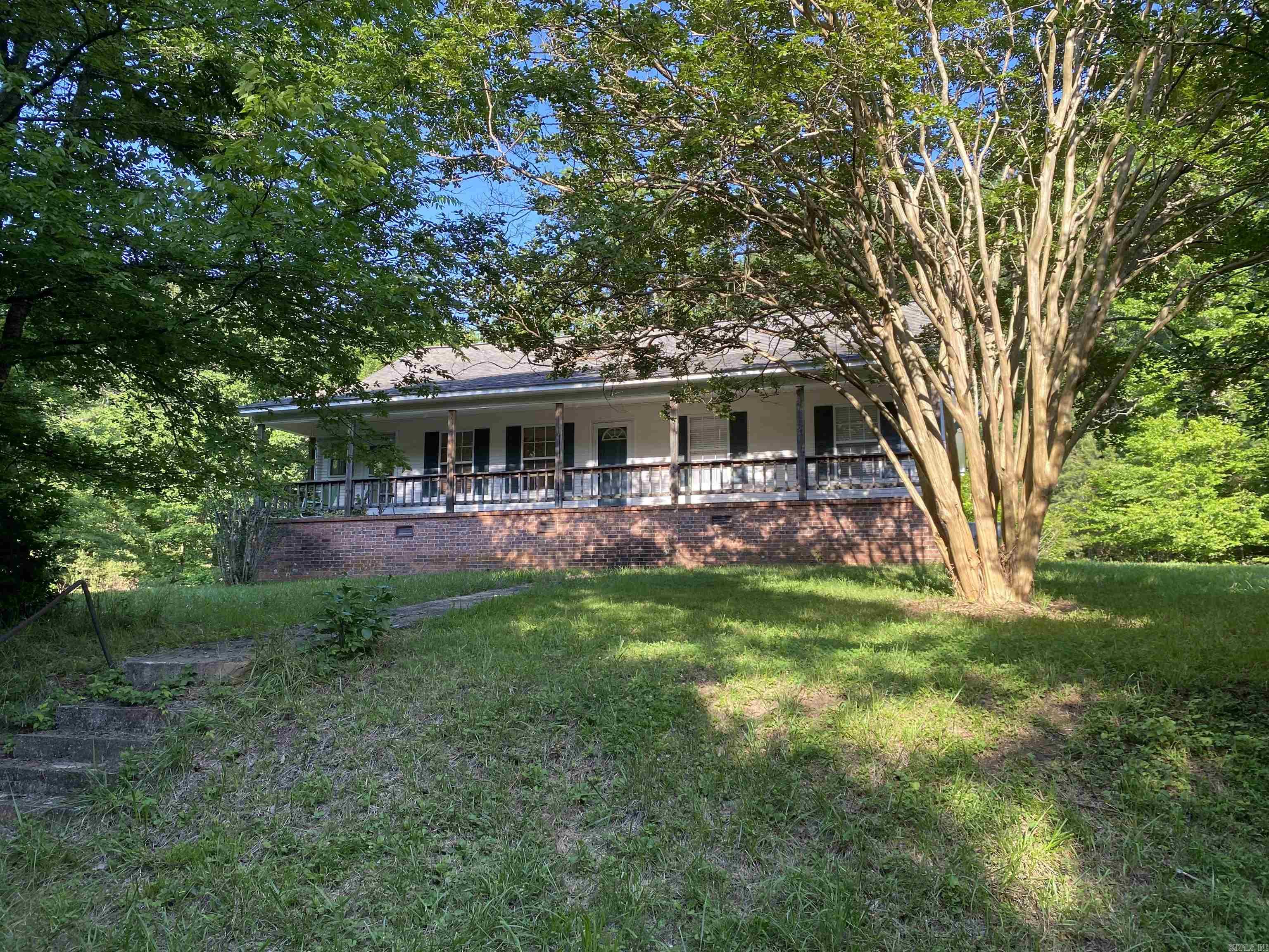 Escape to the beauty of the Ouachita Mountains with this exceptional riverfront property located directly on the crystal-clear waters of the Caddo River. This unique property offers the Arkansas lifestyle you have been dreaming about. Containing 34.83 acres m/l & bordering the Ouachita National Forest, this is the perfect place for hunting, fishing, kayaking, or enjoying star gazing from the open fields or right from the glassed-in porch of your home. The house includes 1476 sq ft of living space with 3 large bedrooms and an open concept design. Just a few steps out the back door is your 3 car detached garage & a lovely spot for all your flowers. Not far from the house, you can take a dip in your own private swimming hole on the river where Polk Creek flows into the Caddo. On the back side of the property, there is a rustic one room cabin for camping or just getting away. Sit on the gazebo overlooking the second creek's waterfall that comes off the National forest onto the property. There is a pole shed, boat storage, and an amazing 2000 sq ft shop building with 3 smaller and 2 large overhead doors, bathroom and office with plenty of room for storage. Amazing property! Call now!