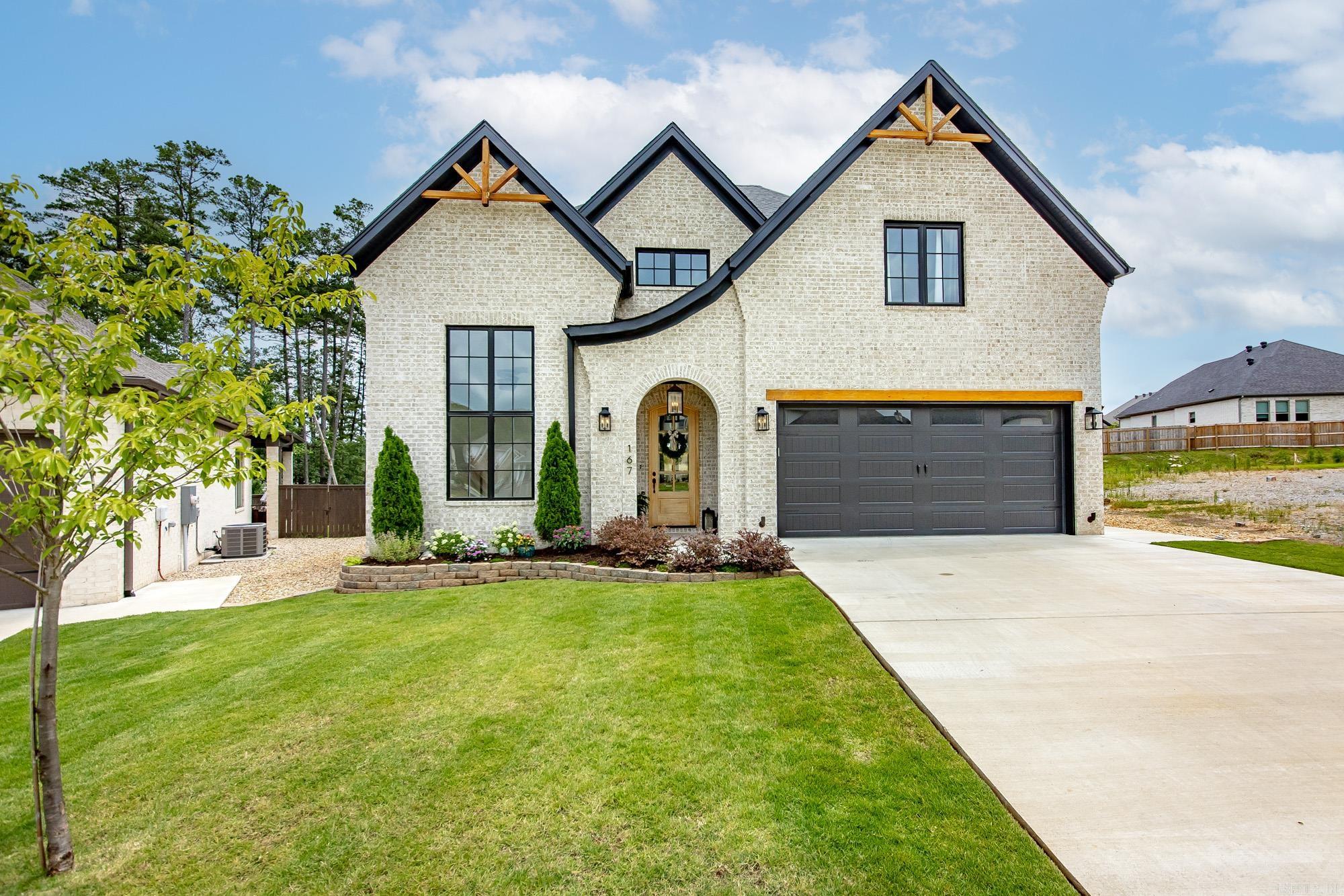 Luxury Lifestyle awaits! Custom built home grabs your attention w/cedar gables & refined Euro-inspired façade signal something extraordinary awaits inside & it delivers. Soaring 12-foot ceilings usher you into a main level w/built in finishes throughout. The Great Room is anchored by a show-stopping Old World German mortar wash fireplace framed by rich cedar wood beams. Natural light pours through illuminating Taj Mahal quartzite countertops that elevate both the chef's kitchen and the luxurious primary bath. The kitchen is a serious entertainer's command center. Outfitted w/a pot filler and a full suite of Bosch appliances including double ovens, a farmhouse sink, wine fridge & a large walk-in pantry complete w/electrical outlets. The primary suite is a true retreat, featuring a custom-built closet & free standing extra-long soaking tub. The second ensuite bedroom with a full bath on the main floor Plus private home office suite. The covered porch complete with wood burning fireplace & fully fenced yard. Garage has extra storage for golf cart & EV charger. Upstairs completes the home with 2 guest bedrooms and generous Bonus room & Ample Walk-in attic storage. Minutes to Costco!