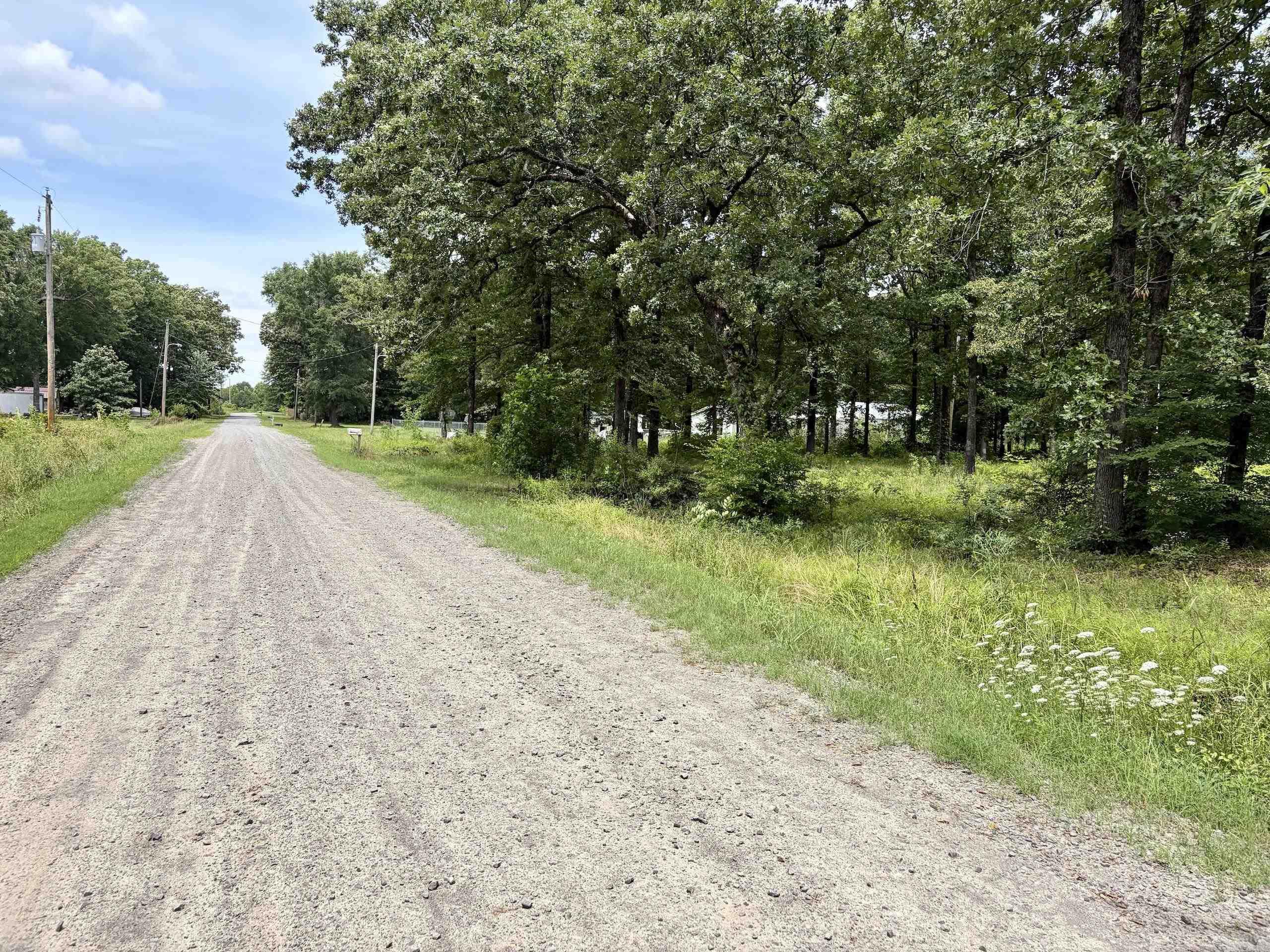 Located just minutes from Beebe, Arkansas, this unrestricted property offers an excellent opportunity for a homesite, hobby farm, manufactured home, or land investment. With many costly improvements already completed, it is ready for immediate use.  Utilities are in place, helping reduce development costs, and a culvert and established entrance provide easy access from a well-maintained gravel county road. The land lies well and features a beautiful mix of open ground and mature timber, creating a park-like setting with privacy and function.  Open areas offer excellent building locations, while scattered timber provides shade, seclusion, and natural beauty. With no known restrictions, buyers have flexibility for a home, shop, barndominium, or rural retreat.  The gentle terrain and existing improvements make this an ideal ready-to-build tract near Beebe, with convenient access to shopping, schools, dining, and employment while still offering the peace of country living.