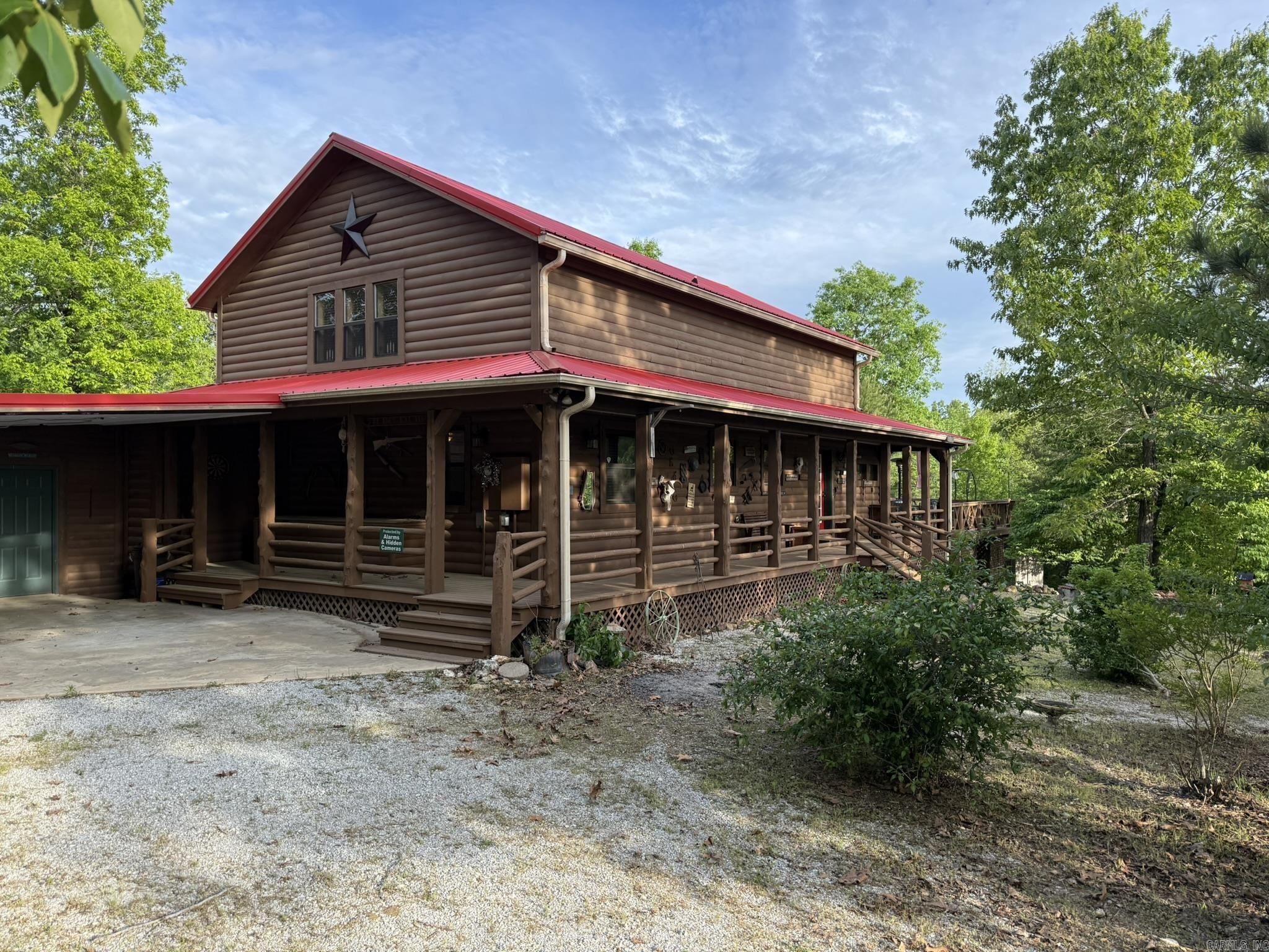 Welcome to Ridgeview: This stunning private Ozark Mountain retreat nestled on 8 acres has a spacious log home just minutes from Mountain View, where music, eateries, and shops fill the old Courthouse Square.  The home boasts high cathedral ceilings, stained glass windows, and large windows that bring the beautiful mountains and skies inside!  The property has large wrap around porches, large fire-pit with seating, as well as other large decks to make outdoor living inviting. There is abundant storage both inside and out.  This home mixes rustic with luxury to give that private paradise you will not want to leave!