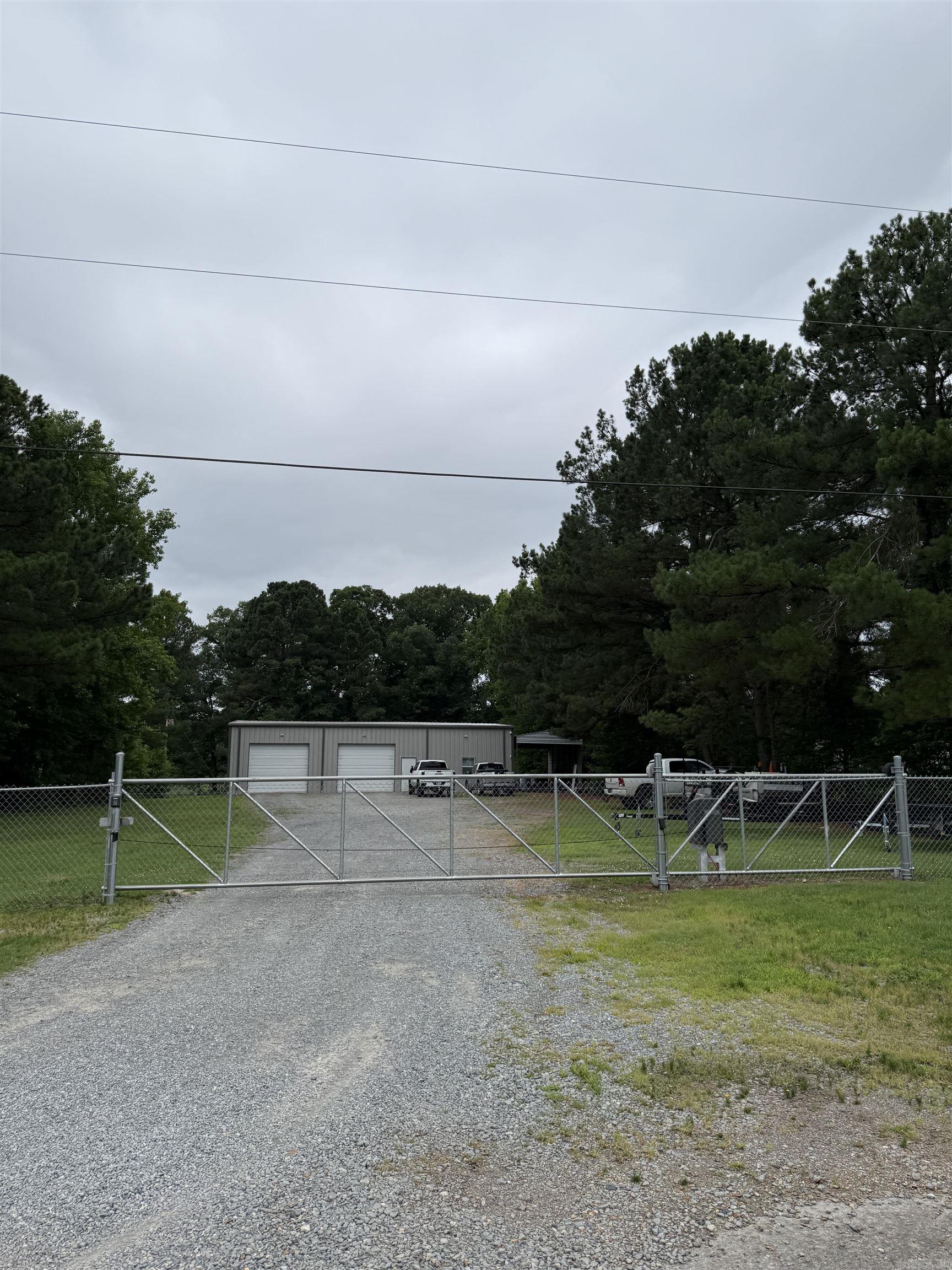 40' x 60' Metal Building on 1 Fully Fenced Acre – Endless Possibilities  Built in 2018, this versatile property features a 40' x 60' metal building equipped with HVAC, plumbing, and a full kitchen, offering flexibility for a variety of uses. The 1-acre lot is fully fenced and secured with an electric gate, providing privacy and controlled access.  Ideal for an auto shop, contractor business, workshop, storage facility, or live/work conversion. With existing utilities and improvements already in place, the property could also be adapted into a shop/apartment combination or customized to fit your specific needs.  Property Highlights:  40' x 60' metal building Built in 2018 HVAC throughout Plumbing installed Full kitchen 1 acre fully fenced Electric entry gate Ample space for vehicles, equipment, or future improvements  A unique opportunity with countless potential uses. Whether you're looking for a business location, workshop, or a property with live/work potential, this one is worth a look