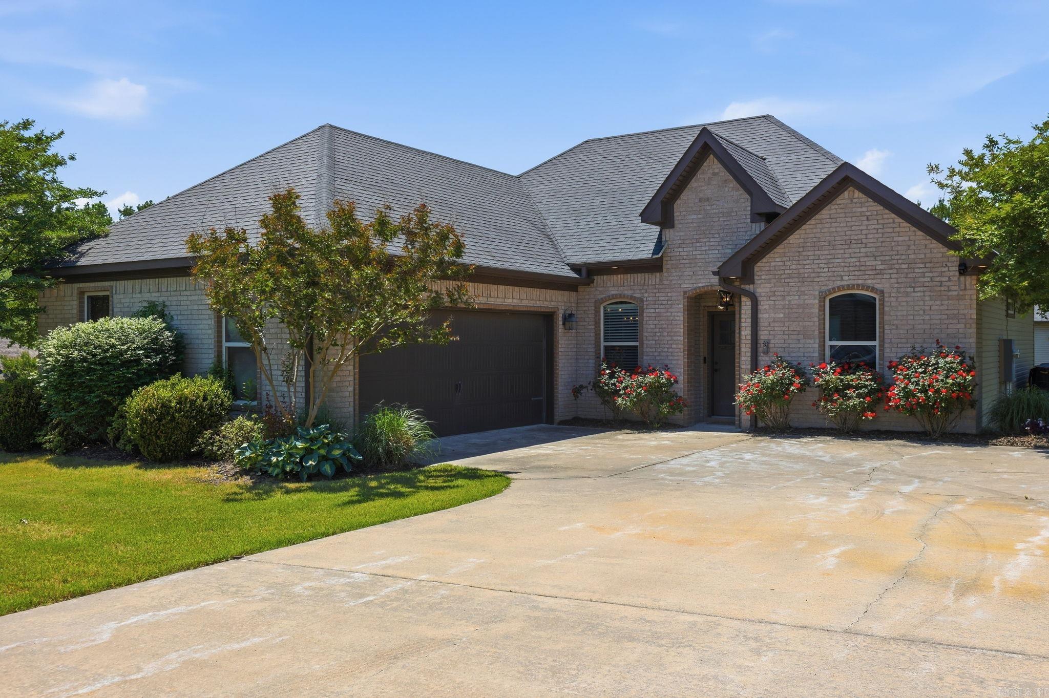 Bring your boat, RV, tools, and big ideas—the 32x35 shop with its own driveway and two oversized overhead doors is the star of the show and a rare find in Benton!  Sitting on a .58-acre corner lot with quick access to I-30 and U.S. Route 70, this 3BR/2BA home blends space, function, and everyday comfort. Inside, you’ll find an open layout with 10’ ceilings in the main living area, 9’ in the bedrooms, crown molding, and a cozy wood-burning fireplace. The primary suite features a walk-through closet that connects directly to the laundry room—because smart design matters.  Out back, the extended covered patio and amazing gazebo create the perfect spot to unwind or host, all overlooking a fully irrigated yard. Add in a 2-car attached garage and low-maintenance brick and vinyl exterior, and you’ve got a property that works as hard as you do—without giving up convenience. NO PESKY HOA!