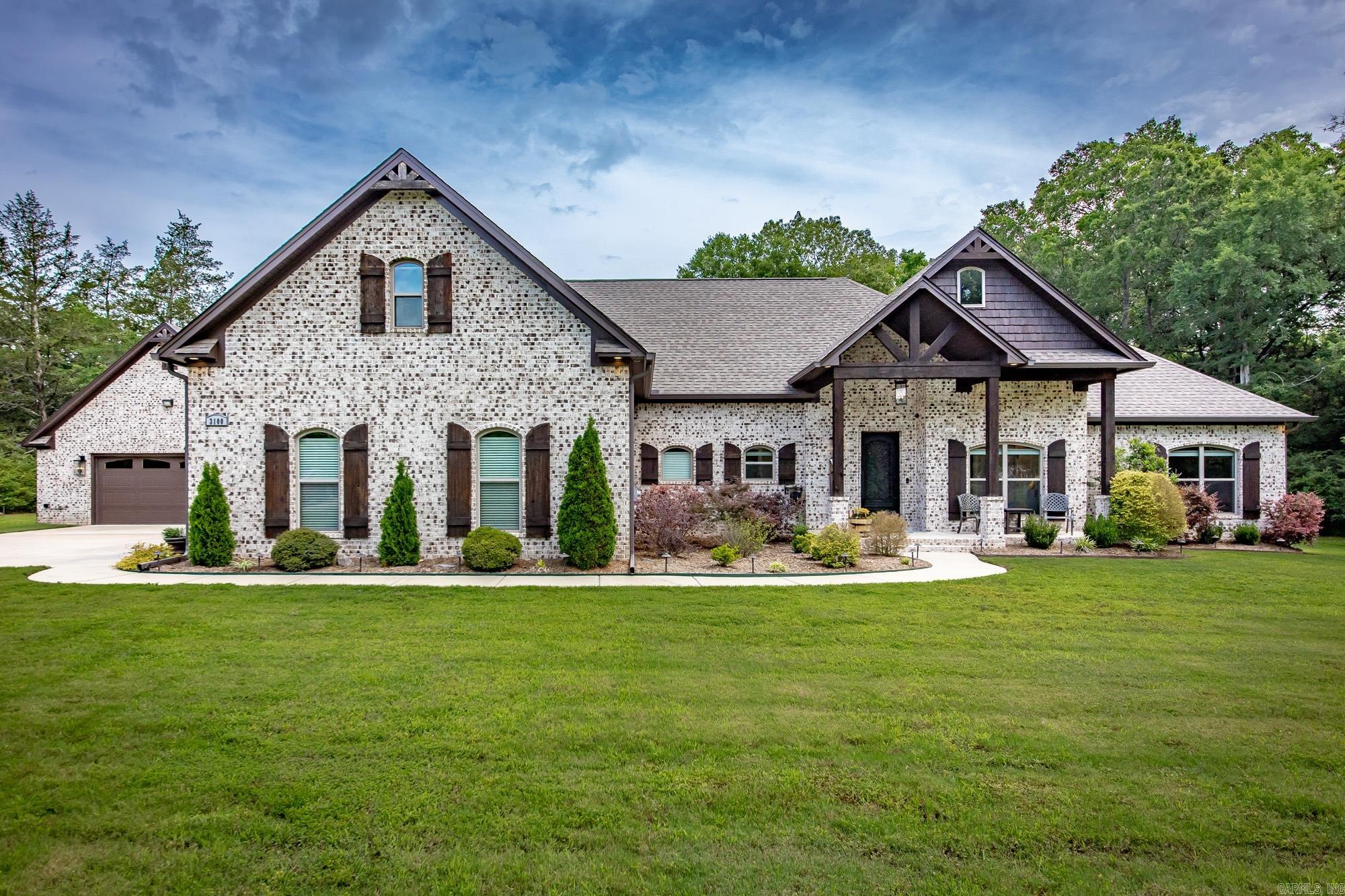 Escape to your own private retreat with this stunning custom-built estate nestled on 2 breathtaking acres surrounded by lush greenery and nature views in every direction. Enjoy the feeling of having no neighbors while still being conveniently located just minutes from shopping, dining, and everyday conveniences. Designed with luxury, comfort, and functionality in mind, this meticulously maintained home offers exceptional attention to detail both inside and out. Step into an inviting layout featuring a dedicated office, spacious bonus room, butler's pantry, tankless water heater, storm shelter and countless high-end touches throughout. Outdoor living is truly unmatched with a resort-style saltwater pool complete with a beautiful water feature and automatic pool cover, plus a fully equipped outdoor kitchen perfect for entertaining year-round. Those needing extra storage will love the oversized 3-car garage along with the impressive detached 30x30 insulated shop offering two additional bays and abundant storage space. This one-of-a-kind property combines privacy, luxury, and convenience in a setting that feels like your own secluded paradise. Schedule your private showing today!