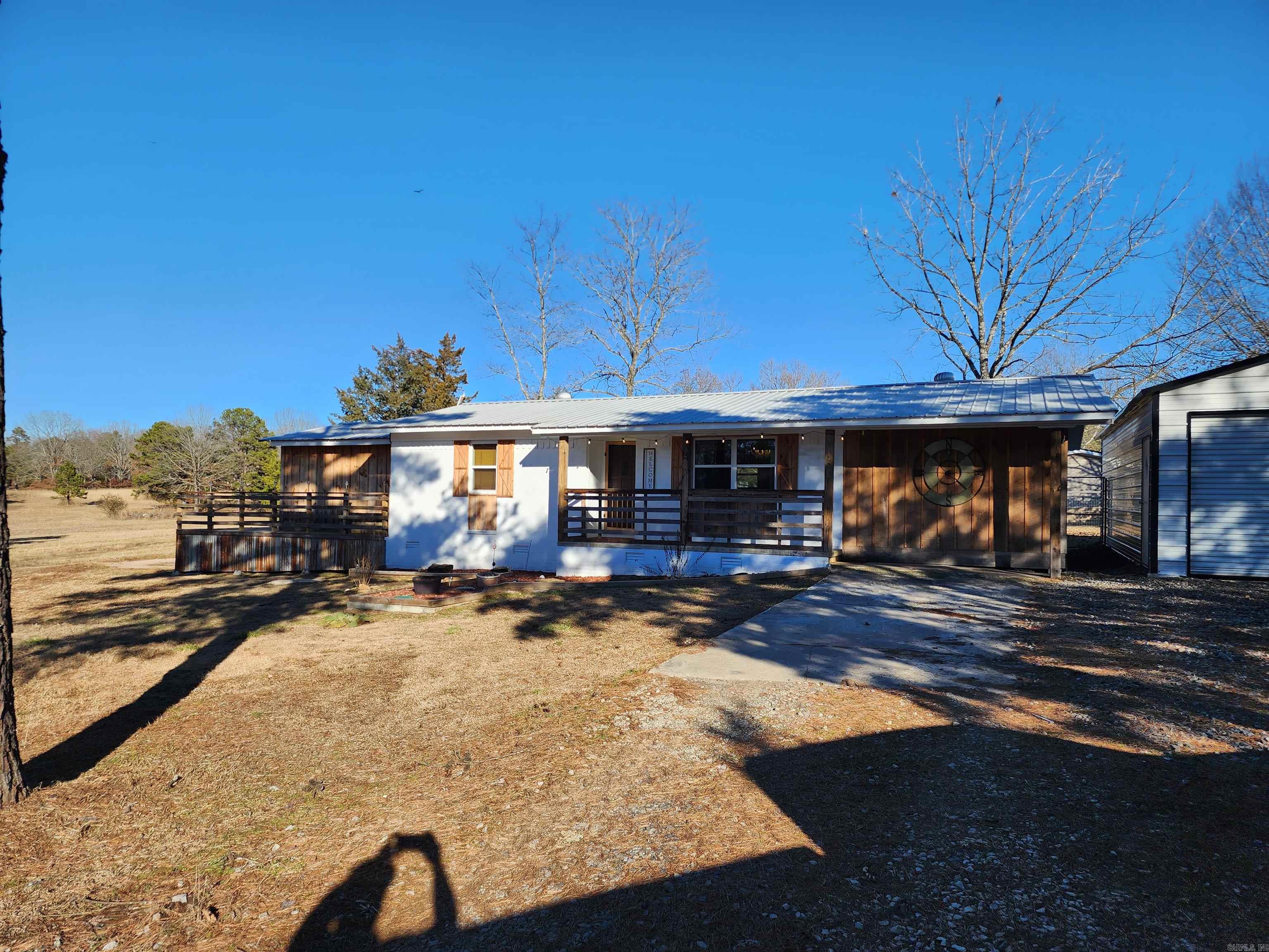 Cozy rustic, farm house with tons of character!  Renovations have been done updating the heating and cooling system, plumbing, electrical, a new metal roof, and structural spray foam insullation sprayed in the crawl space.  Finishes such as the reclaimed wood floors and doors, open kitchen shelving, and rustic light fixtures helped to retain the charm this house offers.  Located less that a mile from Old Hwy 25 Campground and Boat Ramp gives easy access to Greers Ferry Lake.  The metal 2 car gargage equipped with electricity and a wood burning stove allows for boat storage or a perfect work shop.