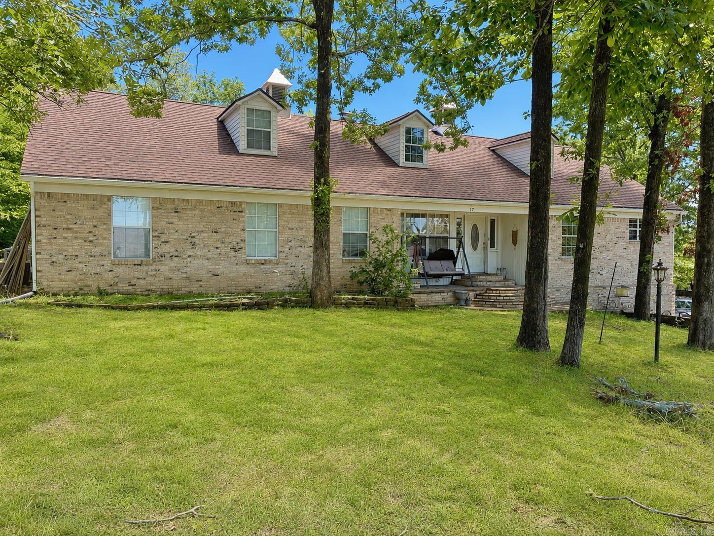 Bring your vision and unlock the potential this spacious 4,289 sq. ft. home has to offer. Located across the street from the lake, this property provides flexibility to accommodate a variety of living arrangements and lifestyle needs. Main level features two generous living areas, two dining spaces, and a wall of windows stretching across the back of the home. Flexible floor plan provides plenty of room for entertaining, multi-generational living, hobbies, or home-based business. Upper level has its own private entrance and functions almost as a separate residence, complete with a kitchen, laundry area, two bedrooms, and a full bath—ideal for guests, extended family, a caregiver suite, or potential income-producing opportunities. A unique feature of this property is the oversized four-car garage/workshop area that extends the length of the home, offering abundant storage, workspace, and even a convenient half bath. Outside, you'll find an additional detached shop with RV storage and a floored attic space that could potentially be finished into additional living quarters. Being sold as-is. With the right updates and improvements, this property could truly shine.