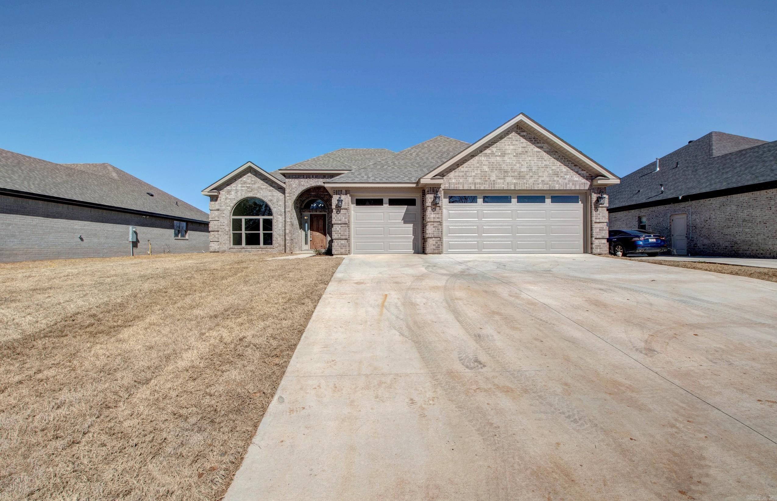 Beautiful all-brick new construction on a level lot in the desirable Country Club of Arkansas subdivision! The inviting covered front porch welcomes you into a spacious foyer and thoughtfully designed one-level floor plan.  A large formal dining room flows seamlessly into the open living area, highlighted by a gas-log fireplace and abundant natural light. The gourmet kitchen is a dream for cooking and entertaining, featuring granite countertops, stainless steel appliances, a gas range, convection oven, oversized pantry, and a large island with breakfast bar seating.  The private primary suite offers a true retreat with a luxurious spa-inspired bath, complete with dual granite vanities, a relaxing soaking tub, custom tiled walk-in shower, and generous closet space.  Three additional bedrooms provide flexibility for family, guests, or a home office. One bedroom, located at the front of the home with a large walk-in closet, is perfectly suited for an office, study, or hobby room.  Step outside to the covered back patio. A spacious 3-car garage.  Photos are of similar finished home. New Construction in framing stage, time to pick your colors and a lot of finished.