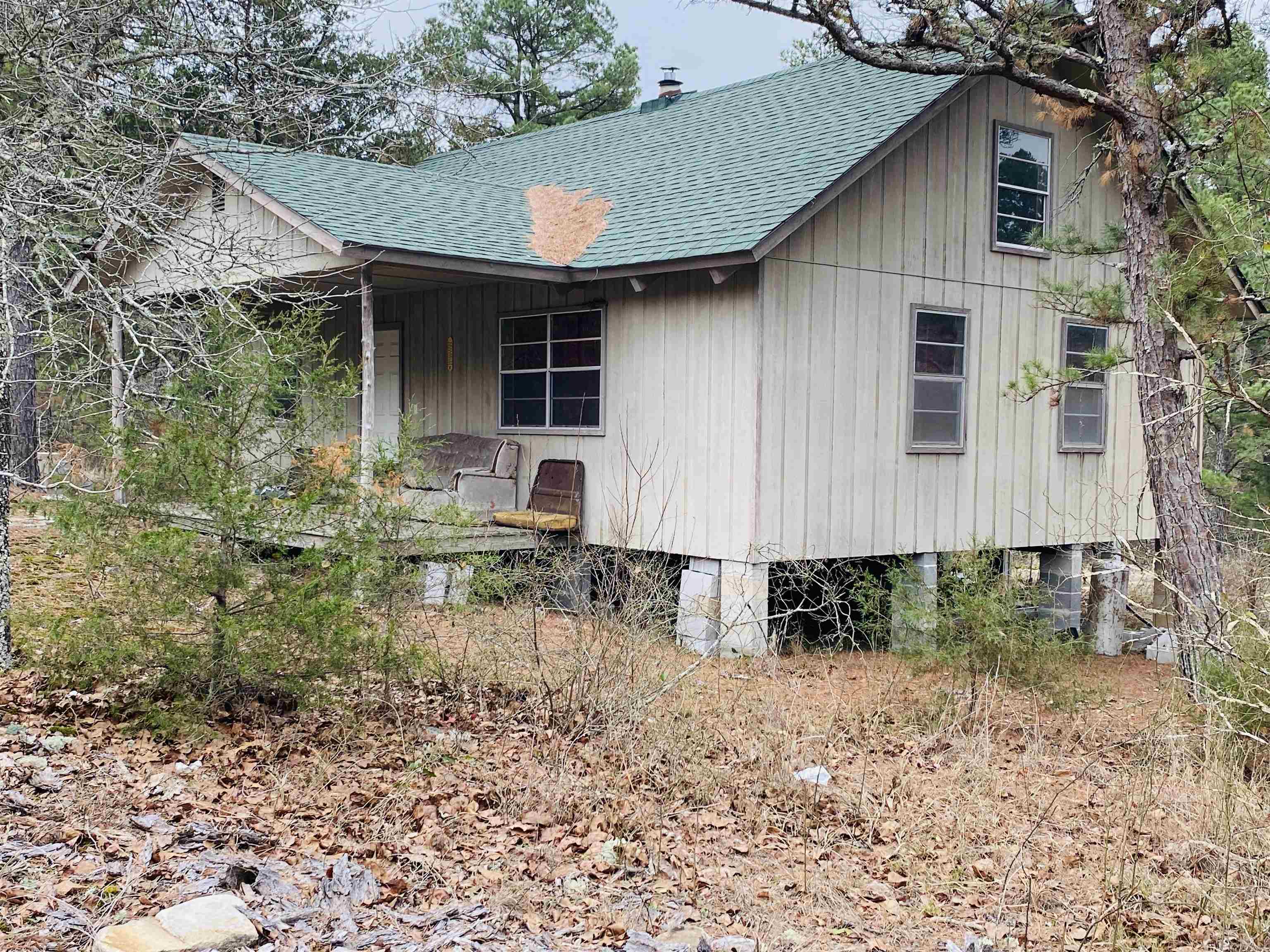 Discover true seclusion with this off-grid hunting cabin situated on 39 wooded acres and surrounded by undeveloped land, offering exceptional privacy and a rural Ozark setting. The 2-bedroom, 1-bathroom cabin features a combined living room and kitchen area, designed for efficient off-grid living. A wood stove provides reliable heat, making this property ideal for year-round use as a hunting retreat or recreational getaway. The cabin is centrally located on the property, with a small creek just behind the home and mature woods throughout the acreage. This land provides excellent habitat for abundant wildlife, including deer and turkey, with bears also known to be spotted in the area—making it a prime hunting and wildlife observation property. Whether you’re looking for a secluded hunting cabin, recreational land, or a private off-grid escape, this 39-acre tract offers a rare opportunity to own a secluded piece of the Ozarks. Offered at $210,000.