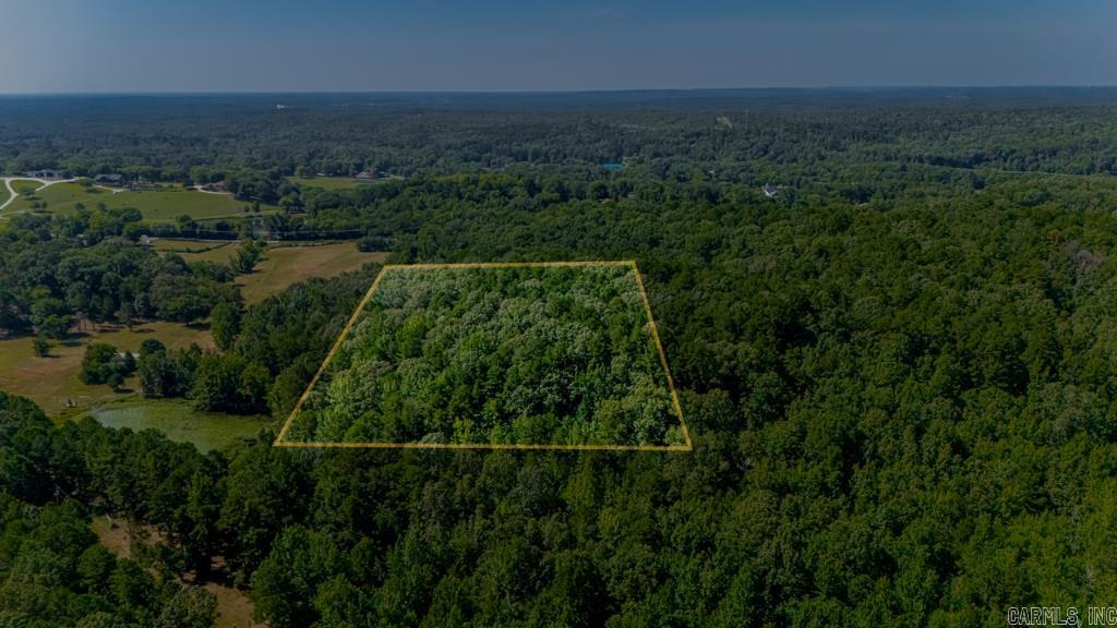 Private 9.91 Acres with Utilities Nearby – Nearly 10 wooded acres (9.91) offering rare privacy just minutes from I-40 and amenities. Outside city limits with residential zoning. Road easement in place, electric available. Ideal for a private estate or investment hold. No HOA. Quiet, wooded setting in a rapidly developing area—perfect for those seeking space, seclusion, and opportunity.