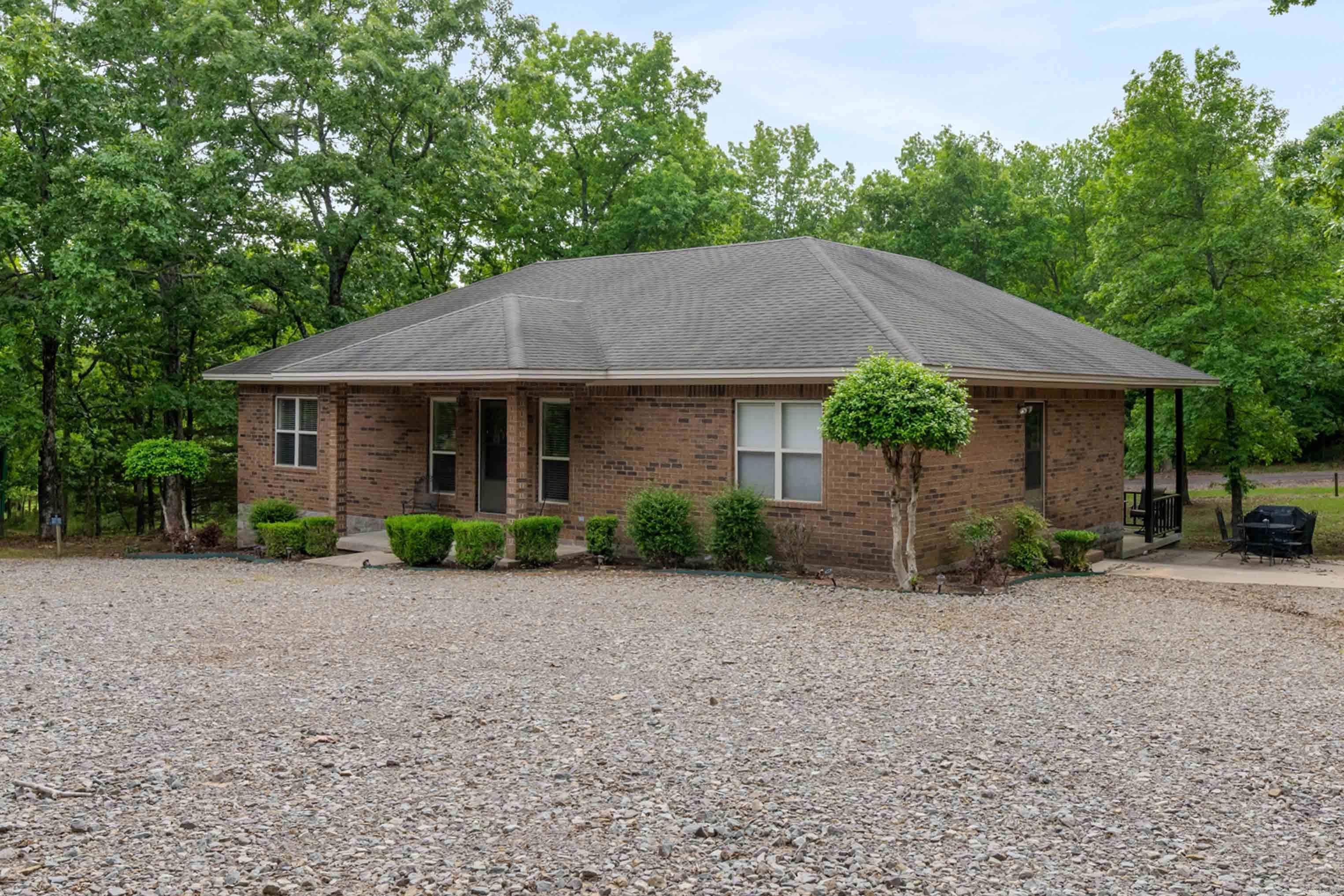 Escape to lake life with this affordable and easy-to-maintain all-brick getaway located just minutes from beautiful Greers Ferry Lake! Whether you are searching for the perfect vacation home, weekend retreat, or investment opportunity, this property checks all the boxes. Designed for comfort and convenience, this spacious home offers 4 bedrooms and 4 private baths, making it ideal for hosting family, friends, or vacation guests. The open kitchen and living area create the perfect gathering space after a day spent boating, fishing, or enjoying the nearby camping and outdoor recreation. Step outside to relax on the covered porch featuring a hot tub — the perfect place to unwind after a fun-filled day at the lake. Additional features include an ice machine, durable all-brick exterior, and low-maintenance living so you can spend more time enjoying the lake life and less time on upkeep.  Offers endless possibilities as a personal retreat, short-term rental, or investment property.  Launch area for your boat or water toys, camp sites or swimming area less than 1/2 mile.  Check it out!
