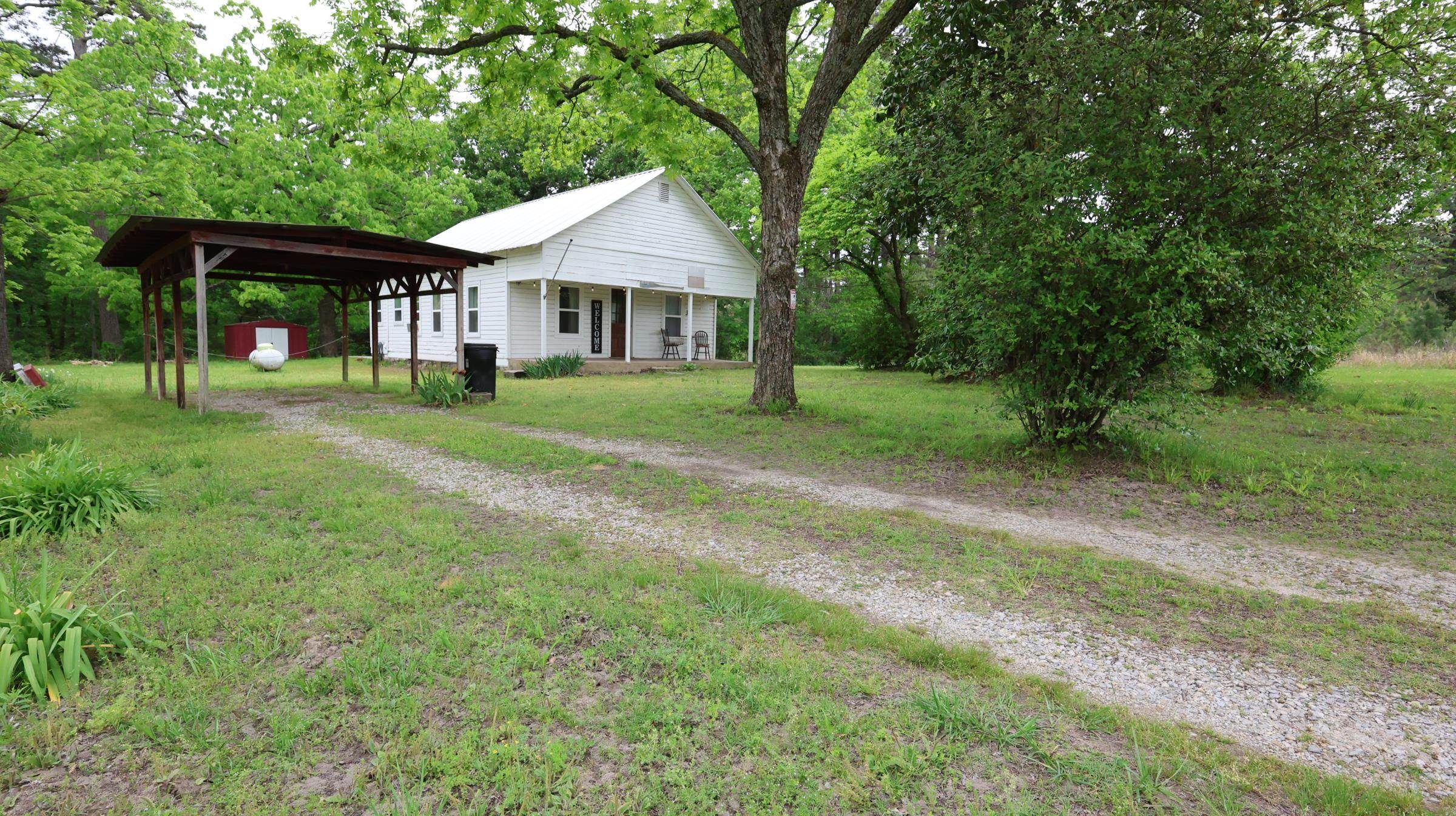 This fully furnished 2-bedroom, 1-bathroom cottage sits on 1 acre in Jordan, Arkansas. Currently operating as a successful Airbnb, this property presents an excellent investment opportunity, short-term rental, or a cozy personal residence. Located less than 3 miles from Jordan Marina on Lake Norfork, you’ll have easy access to boating, fishing, kayaking, and more, with the White River, hiking and jeep trails, restaurants, and shopping all nearby. Originally built in 1921 and once used as a schoolhouse, the home features 864 sq ft of updated living space with reclaimed wood from the original barn, giving it a unique and rustic charm you won’t find anywhere else. Enjoy scenic Ozark views from the front porch overlooking a farm and pond, creating the perfect setting to relax and unwind. The property offers parking for two boats and two vehicles, a carport, outdoor entertainment, and an outdoor storage shed.  Listed for only $159,900.