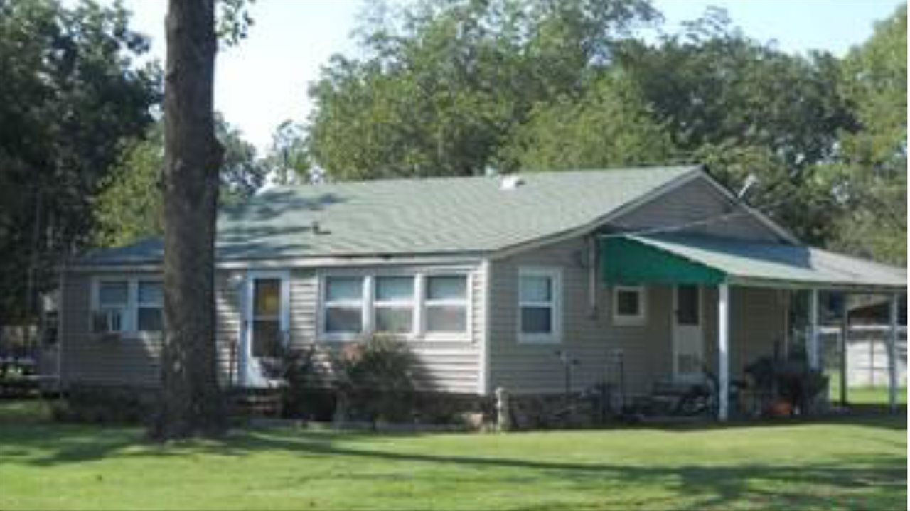 Investment opportunity!  House, shop, storm cellar sitting on 3 city lots. Plenty of room to add additional properties. Seller has updated windows and hot water heater recently.  Additional sewer and utilities are already set-up where a mobile home used to be.