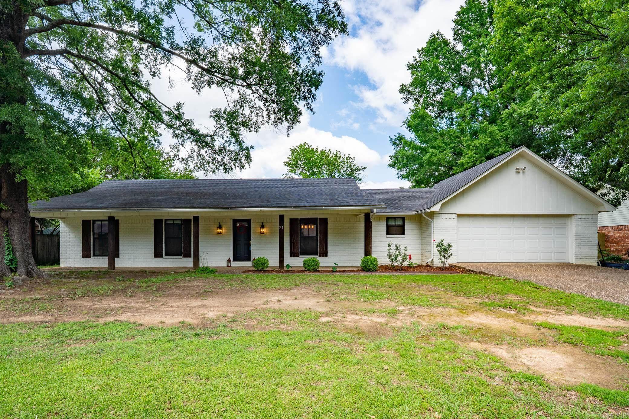 This charming 3 bedroom, 2 bath home combines timeless character with stylish updates. The adorable white painted brick exterior, accented with cedar posts and a spacious front porch, creates the perfect welcoming first impression.  Inside, you'll love the newly installed hardwood floors along with updated kitchen cabinets and countertops completed in 2025. The large great room offers plenty of space to gather and features a wood-burning fireplace as the focal point of the home. Step outside to a huge fully fenced backyard with room to relax, entertain, or enjoy outdoor living.  A wonderful place to call home!  See Agent Remarks