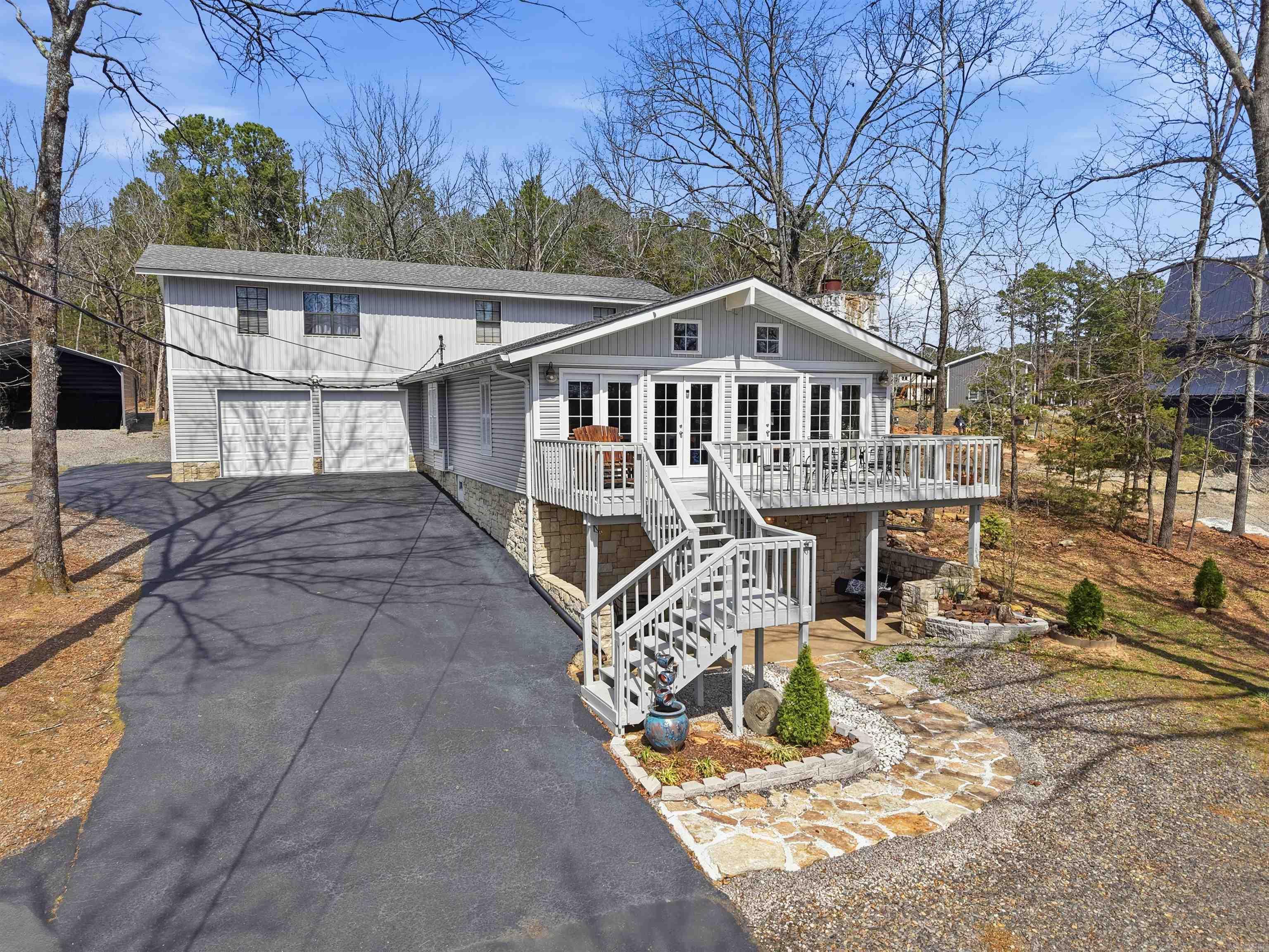 Discover lakeside at living at its finest in this meticulous-maintained home, perfectly positioned just across the street from Greers Ferry Lake in exclusive Belmont Acres located in Tumbling Shoals AR. With a isolated boat launch ramp located in the neighborhood just 200 yards away, this property is ideal for boating enthusiasts. The property features ample room to easily turn boat trailers around, plus dedicated covered storage for all your lake toys and equipment. Outdoor living is effortless thanks to mature trees that provide natural landscaping complemented by additional manicured plantings, a relaxing fire pit, a charming she-shed, extra storage with a convenient roll-up door, and a spacious 20’ x 25’ covered parking area. The double garage and low-maintenance exterior make ownership truly carefree. Inside this all-electric gem, premium finishes shine throughout the 4 bedrooms and 3 full baths. Enjoy quartz countertops, elegant ceramic tile showers, a gourmet chef's kitchen with a large pantry, and a cozy wood-burning stone fireplace. This turnkey, higher-end residence is ready for you to enjoy the lake lifestyle in style and comfort.
