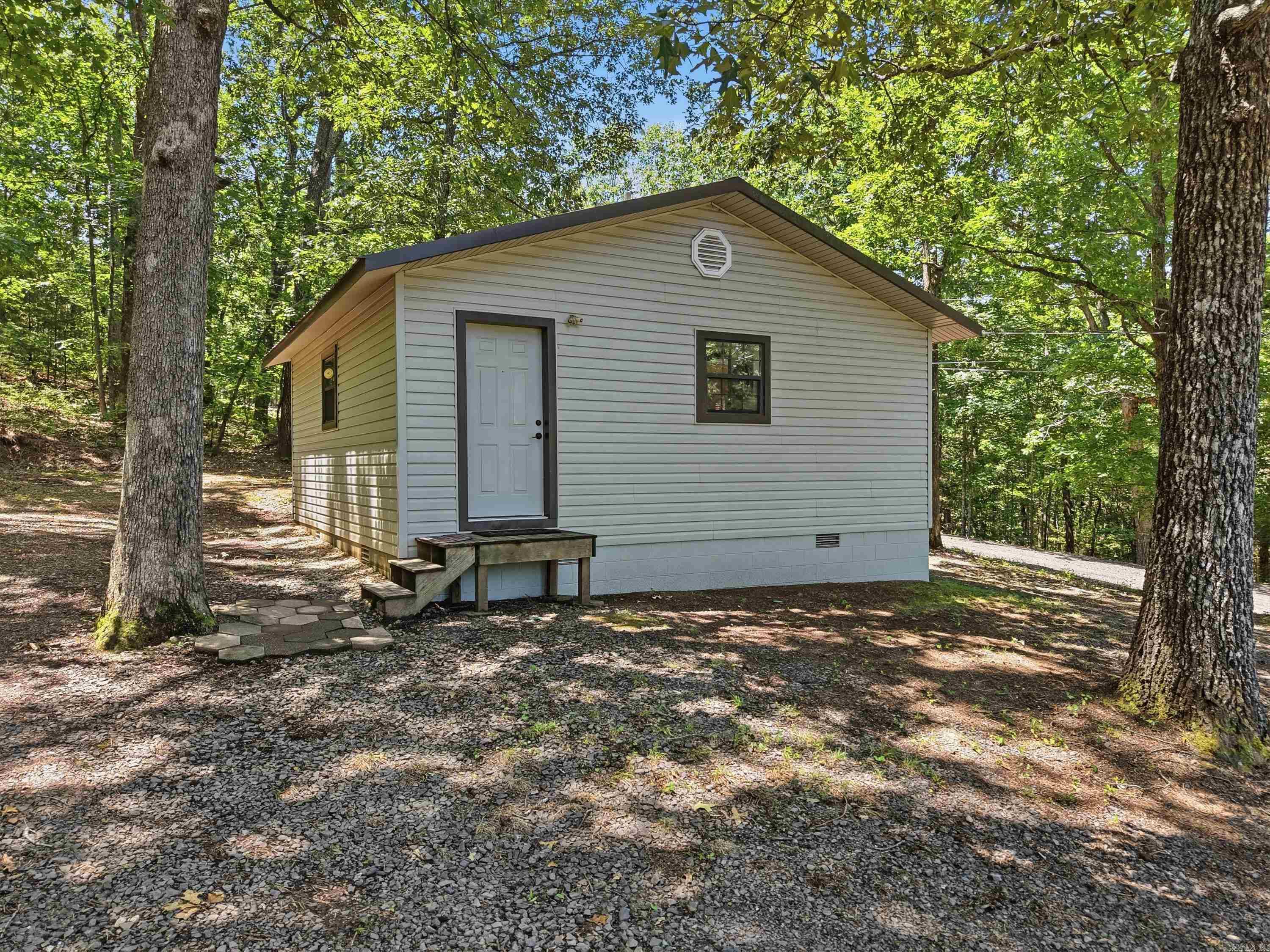 Great cabin near Greers Ferry Lake with plenty of possibilities! Whether you're looking for a weekend getaway, full-time residence, or Airbnb investment, this property is ready to go.  A new refrigerator, two mini-split units and a recent refresh of the interior and exterior make this property move-in ready. The home is total electric with low utility costs, and all furnishings plus lawn care equipment will convey with the sale. A 20' Connex storage building provides extra storage, and there's plenty of parking with room to add a shop or carport. An additional lot across the street offers a great spot for boat, camper, or extra vehicle storage. Located less than 8 miles from Choctaw Marina and boat launch, you'll have easy access to Greers Ferry Lake and all it has to offer. According to the locals there is swimming hole, access to the lake and small boat launch less than half a mile away.