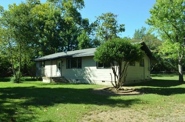 Newly remodeled home with fresh paint inside and out and new carpet and wood flooring. Glass tiled back splash in kitchen with pretty wood floors and nice appliances.  Home sets on a large lot with lots of pretty trees and shrubs.  Covered back porch and partial fencing. New central heat and air.  Home is all electric, but has gas hookup available.