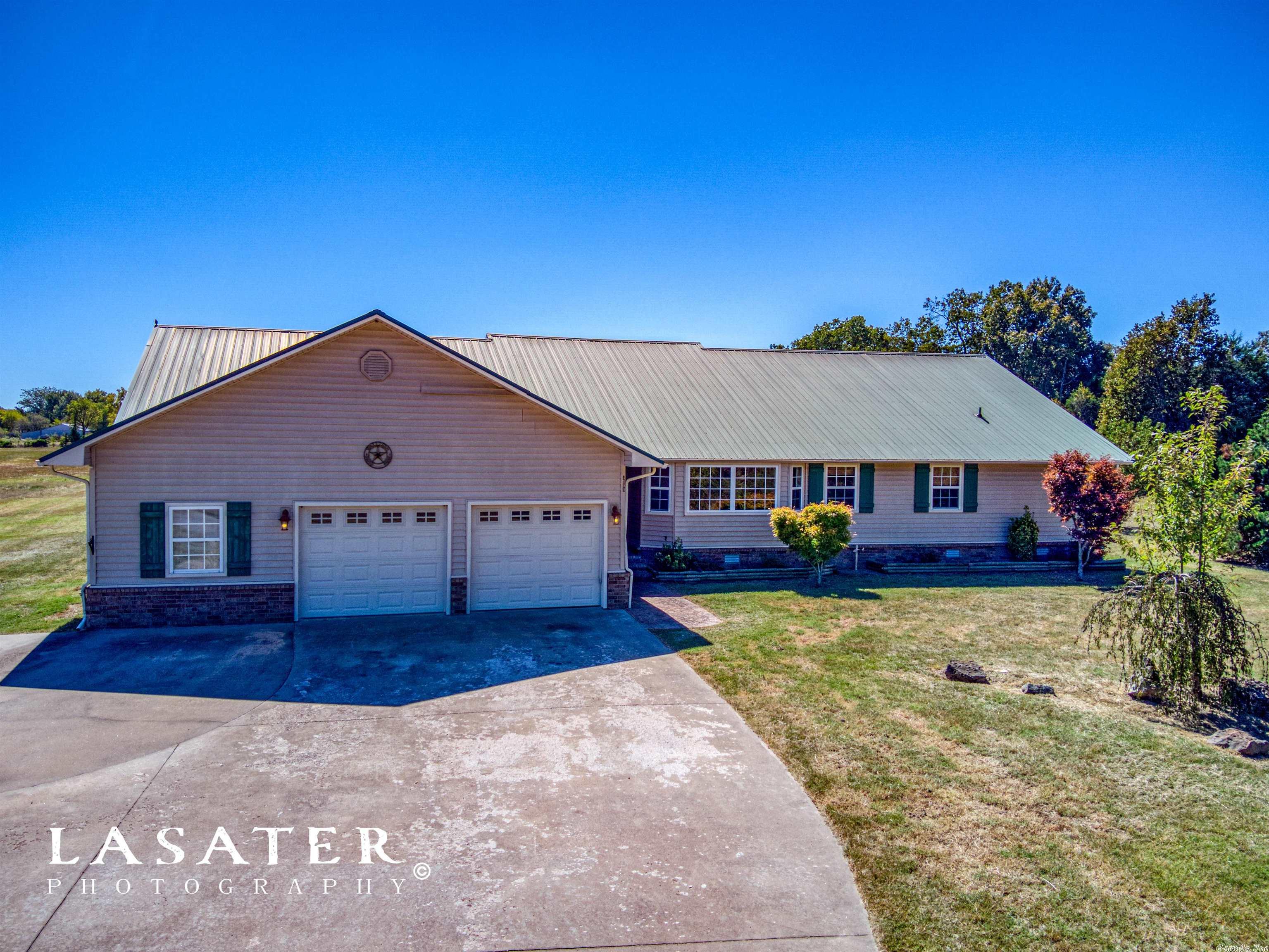 3,100 square feet all on one floor with 18.25 flat acres ready for your animals. This property has 4 bedrooms 3 1/2 bathrooms with a 30 x 40 metal barn. Throw in the fact that you're at the end of a private lane, located only 10 minutes from town, and you have the perfect property! The above ground pool and hand ball court create a great outdoor experience for your family and friends. Come take a look at this mini farm!!