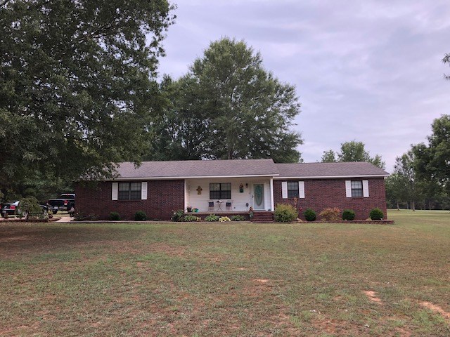 Lovely country home sitting on 7 quiet acres with a 30 x 40 shop that every man dreams of having!!  This all-brick home features fresh paint, updated lighting,  wood laminate plank floors, a huge mudroom/laundry area, a sunroom that can serve as an extra living area/office or exercise room, a spacious kitchen, double vanity in the Master and nice walk-in closet, and a storm cellar!  The utilities are very reasonable and the roof is less than 5 years old.  A Train heat pump was installed in 2012. Call today!