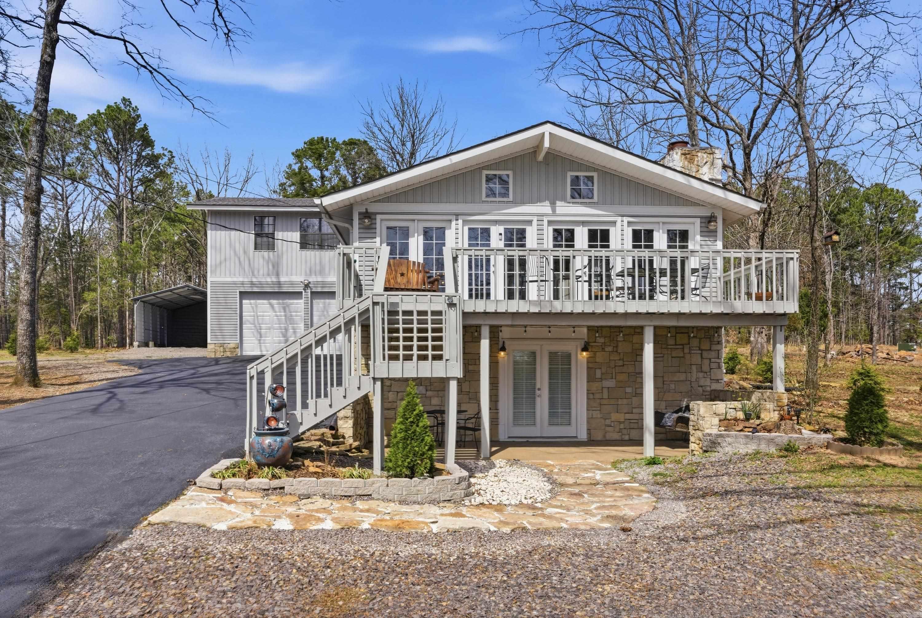 Experience lake living at its best in the desirable Belmont Acres community! This beautifully maintained home offers breathtaking seasonal views of Greers Ferry Lake and is located just approximately 200 yards from the private neighborhood lake access and boat launch, making it easy to enjoy boating, kayaking, fishing, and swimming.  Designed with everyday living and entertaining in mind, the spacious main level features an open floor plan, a dream kitchen with a large island, quartz countertops, abundant cabinetry, and comfortable living spaces perfect for gathering with family and friends. Multiple levels provide plenty of room for guests, including spacious bedrooms and additional living space ideal for extended family, a home office, or recreation.  Step outside to enjoy multiple decks, peaceful wooded privacy, mature landscaping, and plenty of storage for boats, jet skis, lawn equipment, and hobbies with a hidden workshop tucked behind the home. Take a golf cart ride through this friendly neighborhood or down to the private picnic area and launch where neighbors enjoy the lake lifestyle year-round.