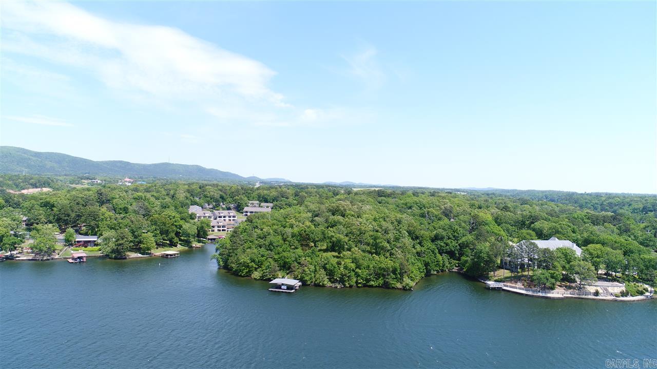Rare opportunity on Lake Hamilton. If privacy and stunning main channel lake views are what you are looking for this property is for you. Over 7 acres with approx 1200 feet on the water. This distinctive property features mature hardwoods, level land that gently slopes to the water and perfect lake front land. Centrally located on Lake Hamilton and convenient to everything you need and want to do in Hot Springs. Historic home site is included as-is.