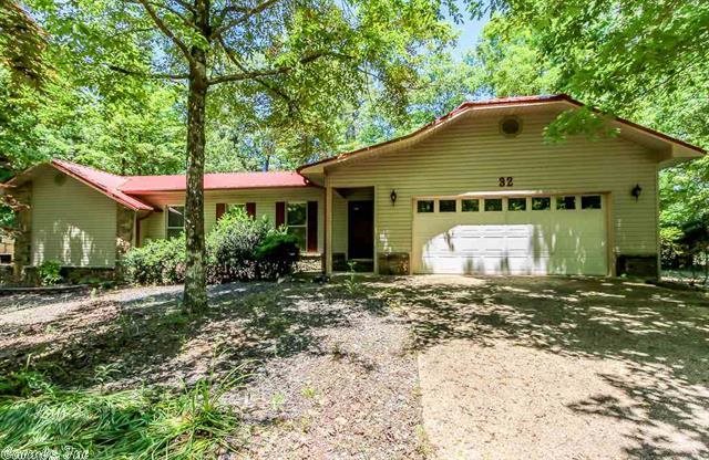 Conveniently located just 5 minutes to the gate find this ranch style home with colored metal roof! 3 bedrooms plus an office (could be used as 4th bedroom if doors were added!) Kitchen features island breakfast bar and dining area and is open to the living area! Wood burning fireplace and wood beams gives a warm lodge like feel! Home sits on a Level lot with mature trees and maintenance friendly lawn nestled in a lovely neighborhood! Excellent attic storage with permanent staircase! One year warranty!