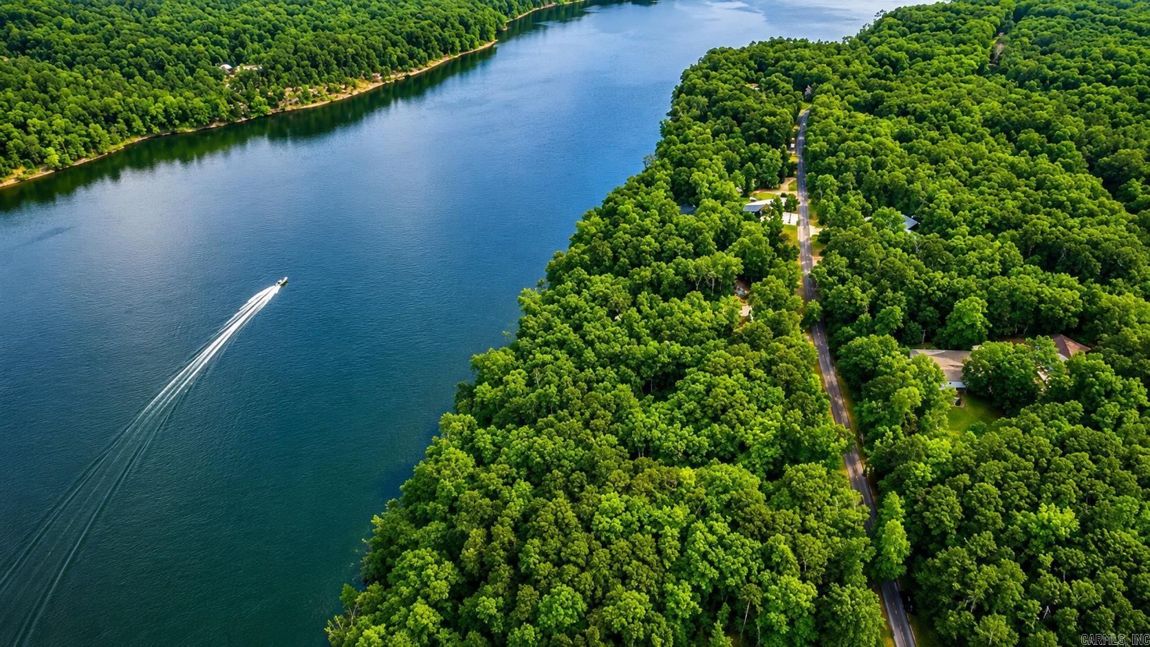 This lake front lot offers the perfect blend of nature, convenience, and potential. Located on a paved road with water and electric available (contact First Electric and Community Water for more info), it’s ready for you to bring your vision to life. Property boundaries were recently marked!! Enjoy an easy walk to the water and take in the peaceful views of Greers Ferry Lake. According to the U.S. Army Corps of Engineers, the property is eligible for a 6-foot path permit (buyer must apply and be approved). Surrounded by nature and just minutes from local restaurants and town amenities, this lot is the ideal spot for a full-time residence, weekend getaway, or investment property. Come experience lake life and make this slice of Edgemont your own! Some photos were taken below the white line
