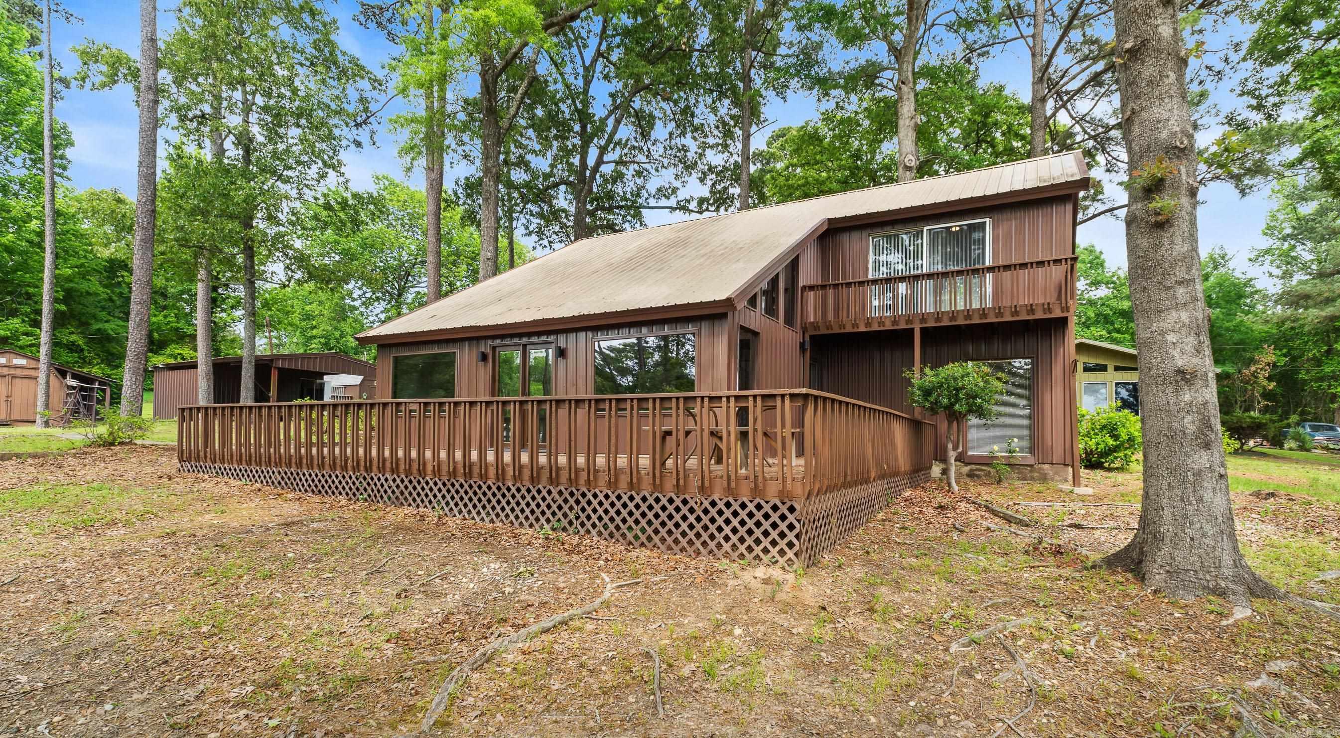 Lake Life + Small-Town Peace at Lake Millwood Welcome to 108 Sunset Dr in Saratoga, AR. This fully updated 3 bedroom, 2 bathroom home sits just steps from the Saratoga boat ramp at Lake Millwood. If you’ve been looking for a fisherman’s setup or a quiet place to unwind, this one checks the boxes. This home has already had the work done for you with new siding, fresh paint, and updated flooring throughout, giving it a clean, move-in ready feel. Outside, you’ll find two outbuildings plus a dedicated fish house, offering plenty of space for storage, gear, or hobbies. Start your mornings on the water and end your evenings on the porch watching the sun set over the lake. The setting here is quiet, peaceful, and built for anyone who enjoys the outdoors, whether that’s fishing, boating, or simply slowing things down. Located in the Mineral Springs School District, just 16 miles from Ashdown and 38 miles from Texarkana, you get the best of both worlds. Convenience when you need it and space when you don’t. If lake life has been calling, this is your opportunity to answer it.