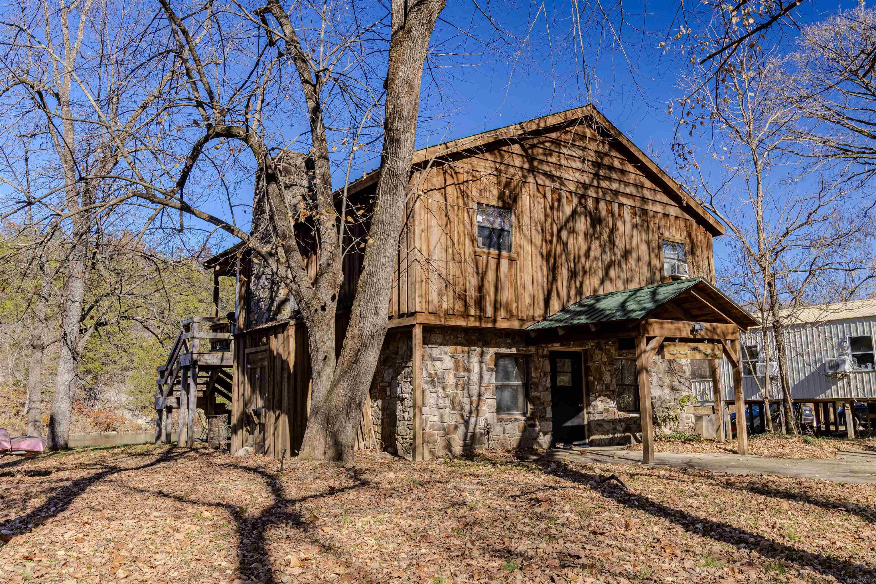 You can't believe the view from the deck of this charming 1546 sq ft 2 story native stone and natural wood cabin directly on the Spring River. Features 2 cozy bedrooms and 1 bath up top with an open living/kitchen area with wood burning fireplace and outstanding waterfall views, plus a lower-level bunk room and full bathroom for extra guests. Enjoy world-class trout fishing, canoeing, and kayaking from your backyard with a beautiful natural waterfall right at the edge of your yard. Also includes large extra buildable lot  947 Saddler Falls Rd Mammoth Springs Cozy, well-kept, and perfect as a getaway or rental in a peaceful Ozark river setting. Home is being sold as-is. $359,900 Contact me today for private showing!