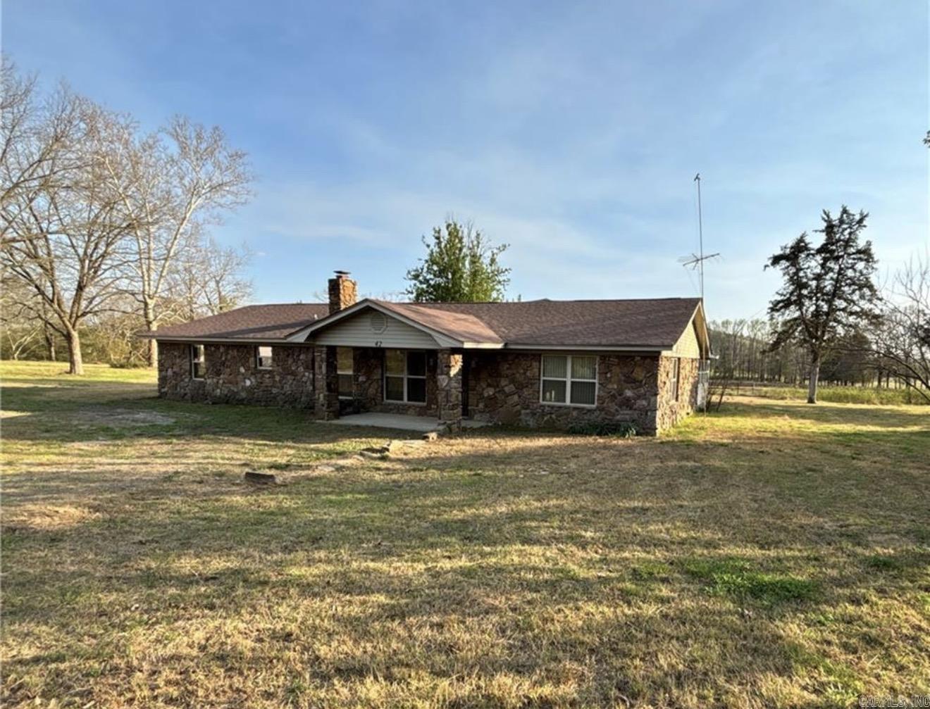 Peaceful setting on 4.5 beautiful acres with no restrictions! This 3-bedroom, 2-bath home offers over 2,000 sq ft of comfortable living space. The property includes a 60x80 garage/shop, as well as beautiful mature pecan trees. The shop offers potential but requires repairs/updating. Experience country living while still being close to amenities—just 15 minutes to Morrilton with easy access to I-40.