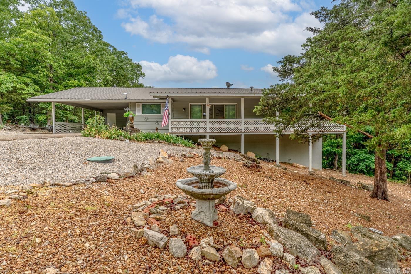 Welcome to Market 63 Pahokee Drive in the Vegas Second Subdivision of Cherokee Village, AR. Set atop a scenic hillside with sweeping panoramic views, this inviting home is surrounded by the beauty of nature. Situated on approximately .26 +/- acres with an additional wooded lot of .30 +/- acres, the property provides added space to enjoy the outdoors. A large covered front porch and spacious back patio create the perfect setting for morning coffee, evening relaxation, or entertaining guests while overlooking the stunning landscape. Inside, you’ll find approximately 1,600 +/- square feet featuring 2 bedrooms, 2 bathrooms, a generous living room, and a separate den area offering flexibility for everyday living. The kitchen is both functional and charming with ample cabinetry, a cast iron oven, and a window above the sink that perfectly frames the breathtaking views. Combining comfort, character, and a tranquil setting, this property is the ideal place to enjoy the natural beauty of Cherokee Village.