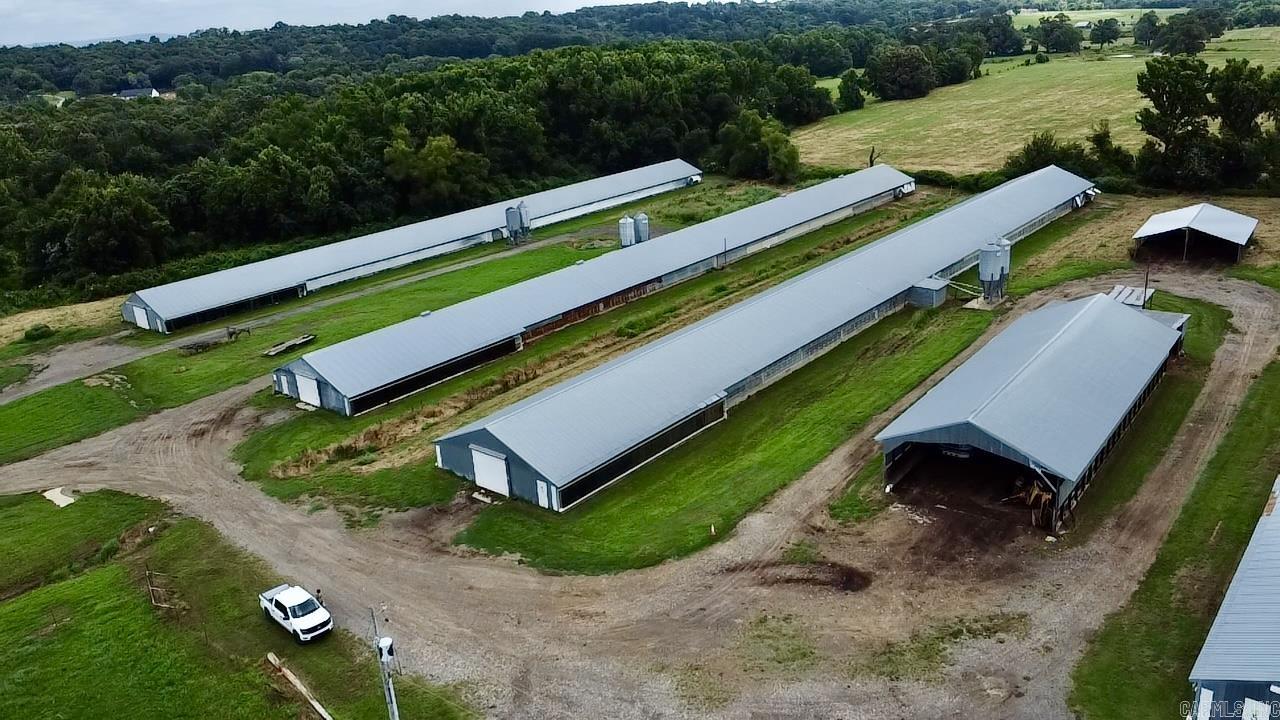 Rare opportunity to acquire a fully operational 5-house Tyson broiler farm situated on approximately 110 acres of productive pastureland and countryside. The operation includes five 40' x 400' poultry houses, a charming 4 bedroom, 2 bath farmhouse, multiple barns and shops, working pens, litter sheds, and a wide array of equipment needed to support the farm. Features include two stock ponds, scattered shade trees, quality well water serving the farm, city water to the residence, two backup generators, and a Gateway computerized automation system for efficient operation. The farmhouse is full of character and offers a welcoming wraparound porch, formal dining room, eat-in kitchen, sunken den, spacious living room, full laundry room with storage, numerous built-ins, and a newer roof. The property is being offered with an extensive list of equipment including a Sterling litter spreader truck, sprayers, box blade, square baler implements, post hole digger, front-end loader, International dump truck, two gooseneck trailers, Kubota cab tractor with front-end loader, hay fork, and a 2016 John Deere 323E skid steer + forks with approximately 2,000 hours. An outstanding opportunity to conti