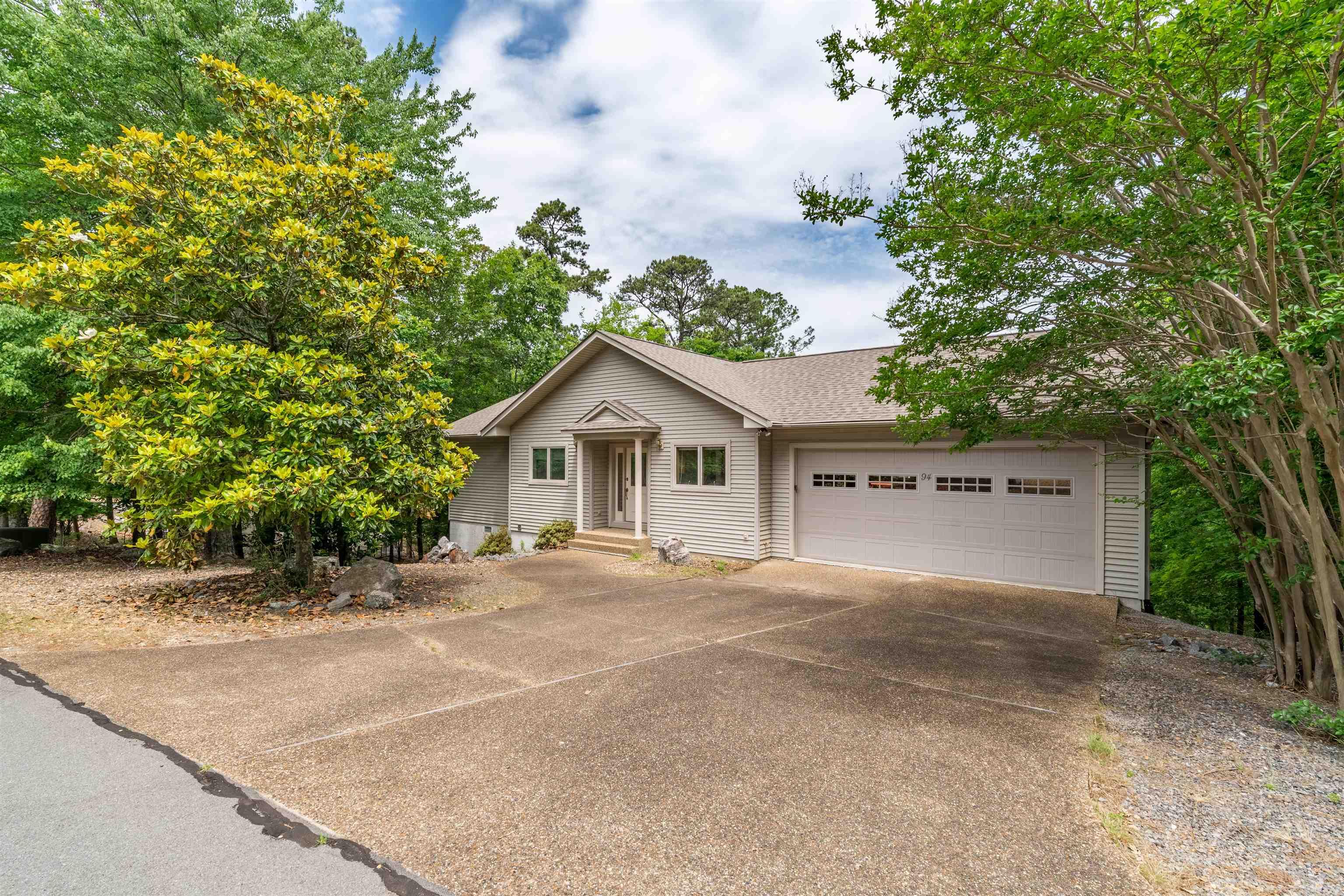 Charming two-level home that offers stunning mountain views and a warm, inviting layout designed for comfort and convenience.  The main level features a spacious primary suite, laundry room, powder room, a separate office ideal for work or hobbies, and a delightful Arkansas room where you can relax and take in the gorgeous scenery.  The living and dining area features rich hardwood flooring, electric fireplace and a vaulted ceiling that enhances the open, airy feel of the space. The lower level provides excellent flexibility with a private second bedroom and full bath, perfect for guests, along with a large workshop that can easily be converted into a third bedroom or additional living area.  Other features include multiple outdoor (covered and uncovered) decks, a two-car garage, and additional storage in the lower-level crawlspace.  Recent updates include a new roof in 2023, a new water heater in 2024, and a newer heat pump (2020), offering peace of mind and added value.  This home blends thoughtful design with beautiful natural surroundings, creating a comfortable retreat with room to grow. Come see all that this home has to offer! Agents see remarks for additional details.