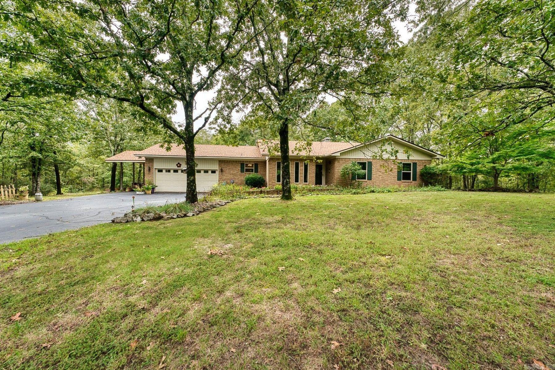 Well-maintained brick home situated on 3 acres outside the city limits, offering space and privacy.  This 3-bedroom 2-bathroom property features a new HVAC system, an inviting sunroom, and an oversized garage.  The fully fenced backyard provides added security and functionality, while covered RV parking and an additional storage building offer excellent options for vehicles, equipment, or hobbies.  Ideal for buyers seeking country living with practical amenities and room to grow.